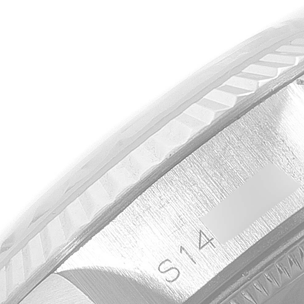 The image shows a close-up of the fluted bezel and part of the serial number of a Rolex Datejust 69174 Women's Stainless Steel Blue Dial 69174 Women's Stainless Steel Blue Dial watch.