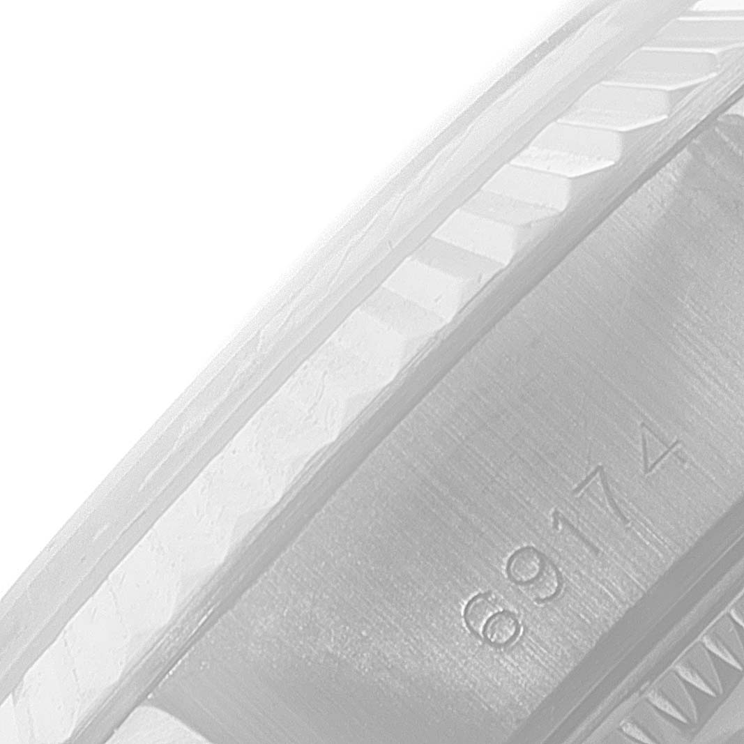 The image shows a close-up of the fluted bezel and part of the case with model number engravings of a Rolex Datejust 69174 Women's Stainless Steel Blue Dial 69174 Women's Stainless Steel Blue Dial watch.