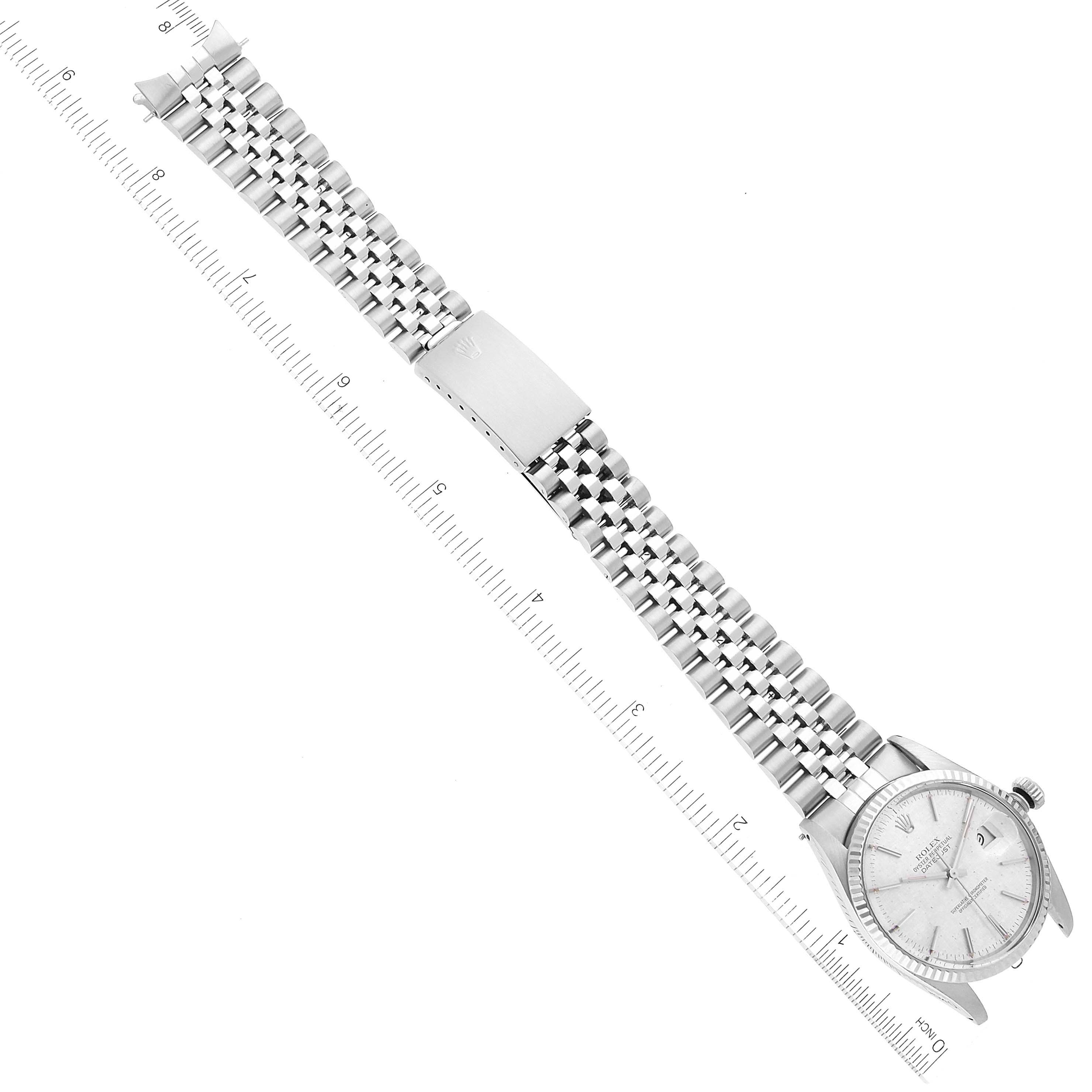 The Rolex Datejust 16014 Men's Stainless Steel Silver Dial 16014 Men's Stainless Steel Silver Dial watch is shown from an aerial angle, highlighting the full bracelet, clasp, and the watch's face.