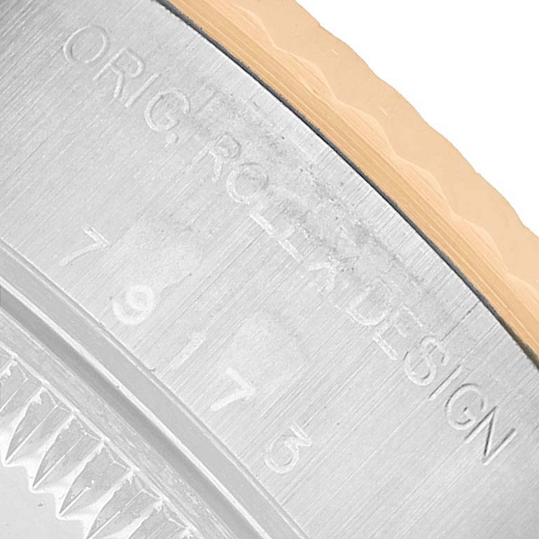 The image shows a close-up of the Rolex Datejust 79173 Women's Steel and Gold (two tone) Champagne Dial model's side, featuring the bezel edge and engraved markings.