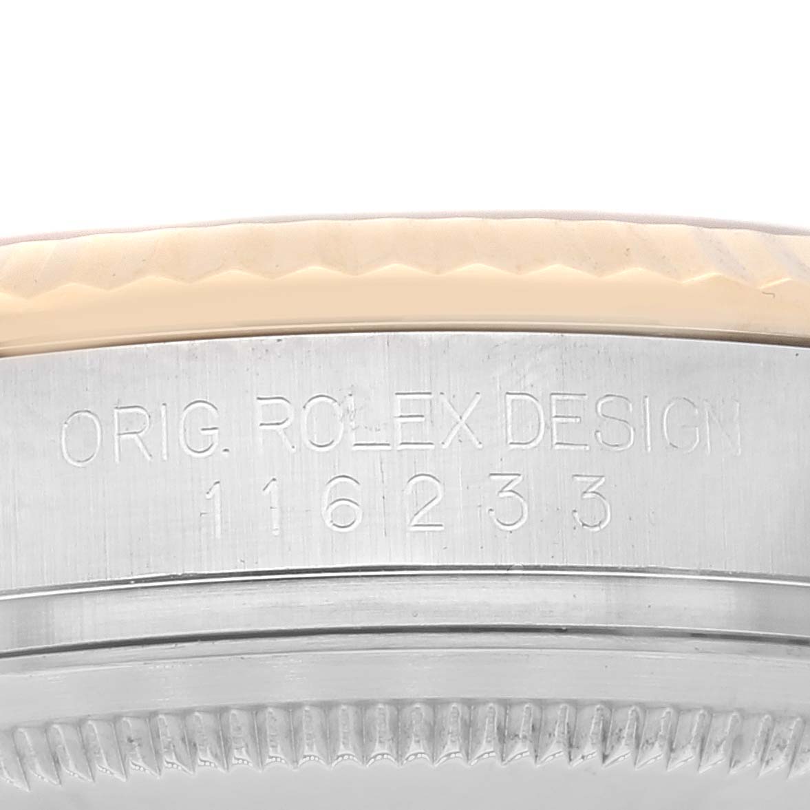 The image shows the side of the bezel and case of a Rolex Datejust 116233 Men's Steel and Gold (two tone) Silver Dial 116233 Men's Steel and Gold (two tone) Silver Dial with "ORIG. ROLEX DESIGN" and model number "116233" engraved.