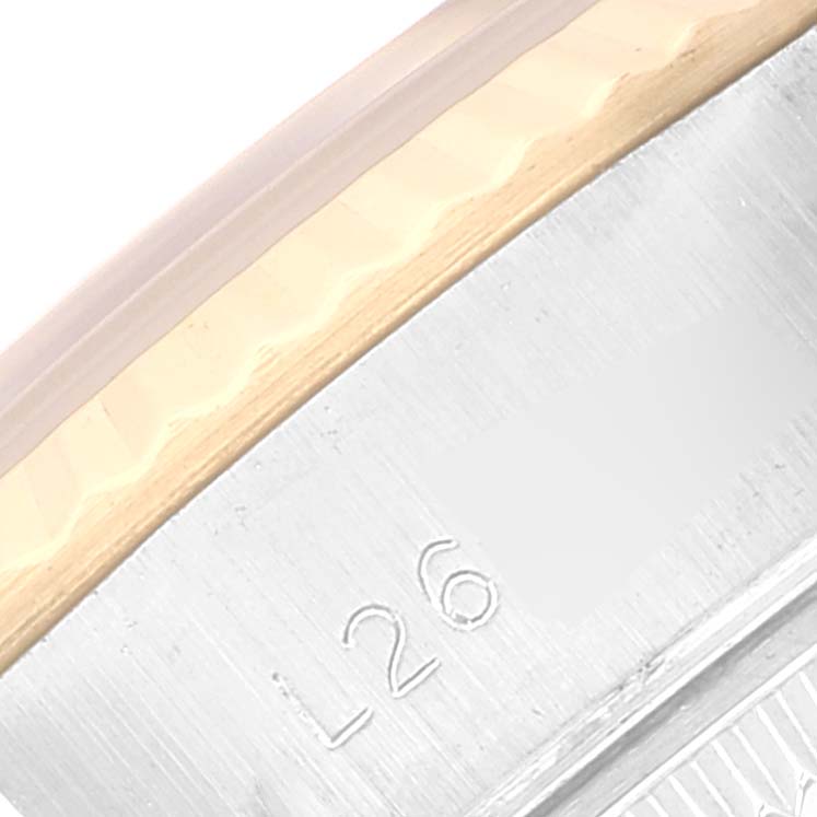 This image shows a close-up of the casing edge and fluted bezel of a Rolex Datejust 69173 Women's Steel and Gold (two tone) Black Dial 69173 Women's Steel and Gold (two tone) Black Dial watch, including part of its engraved identification markings.