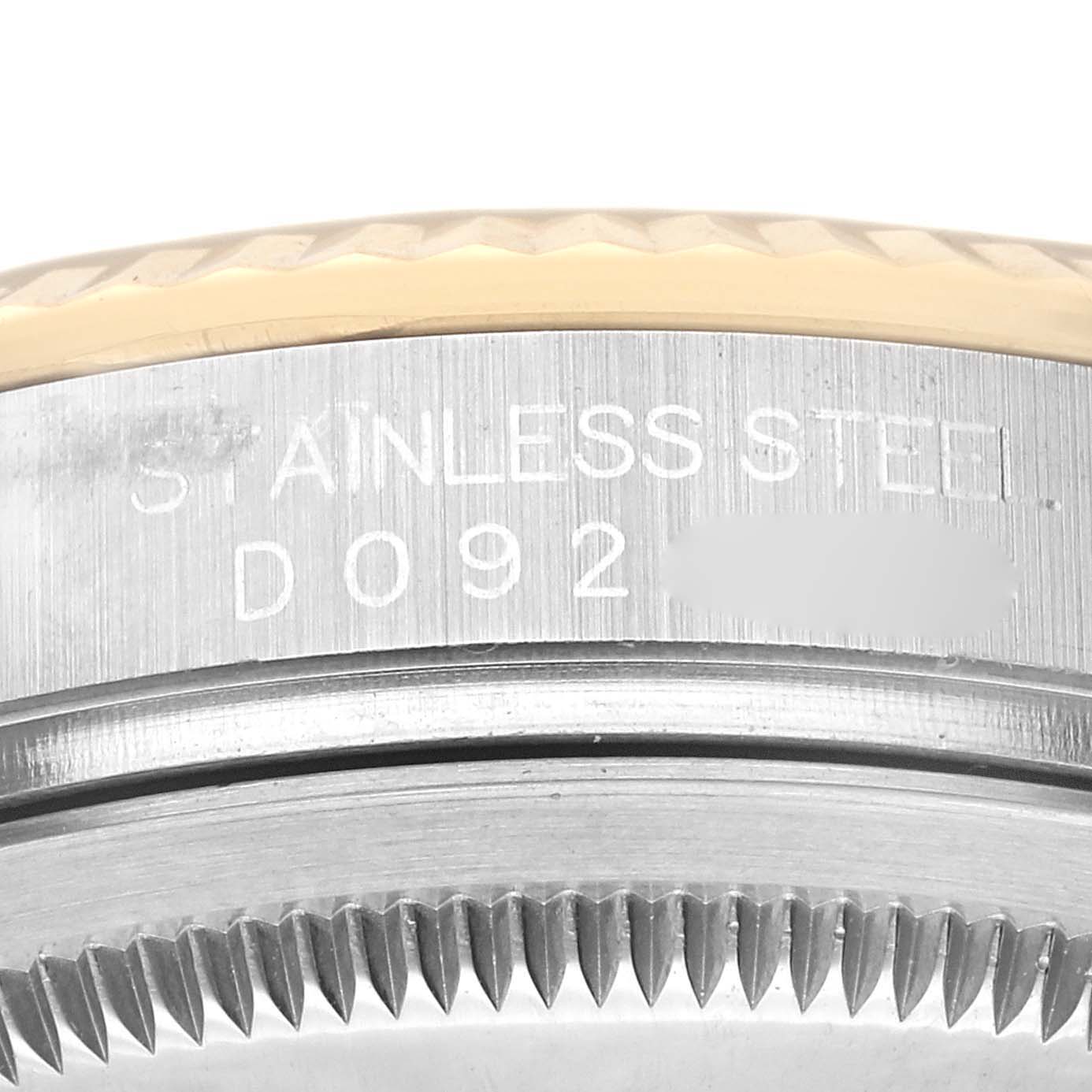This image shows a close-up of the serial number engraving and bezel teeth of a Rolex Datejust 116233 Men's Stainless Steel Black Dial 116233 Men's Stainless Steel Black Dial watch.