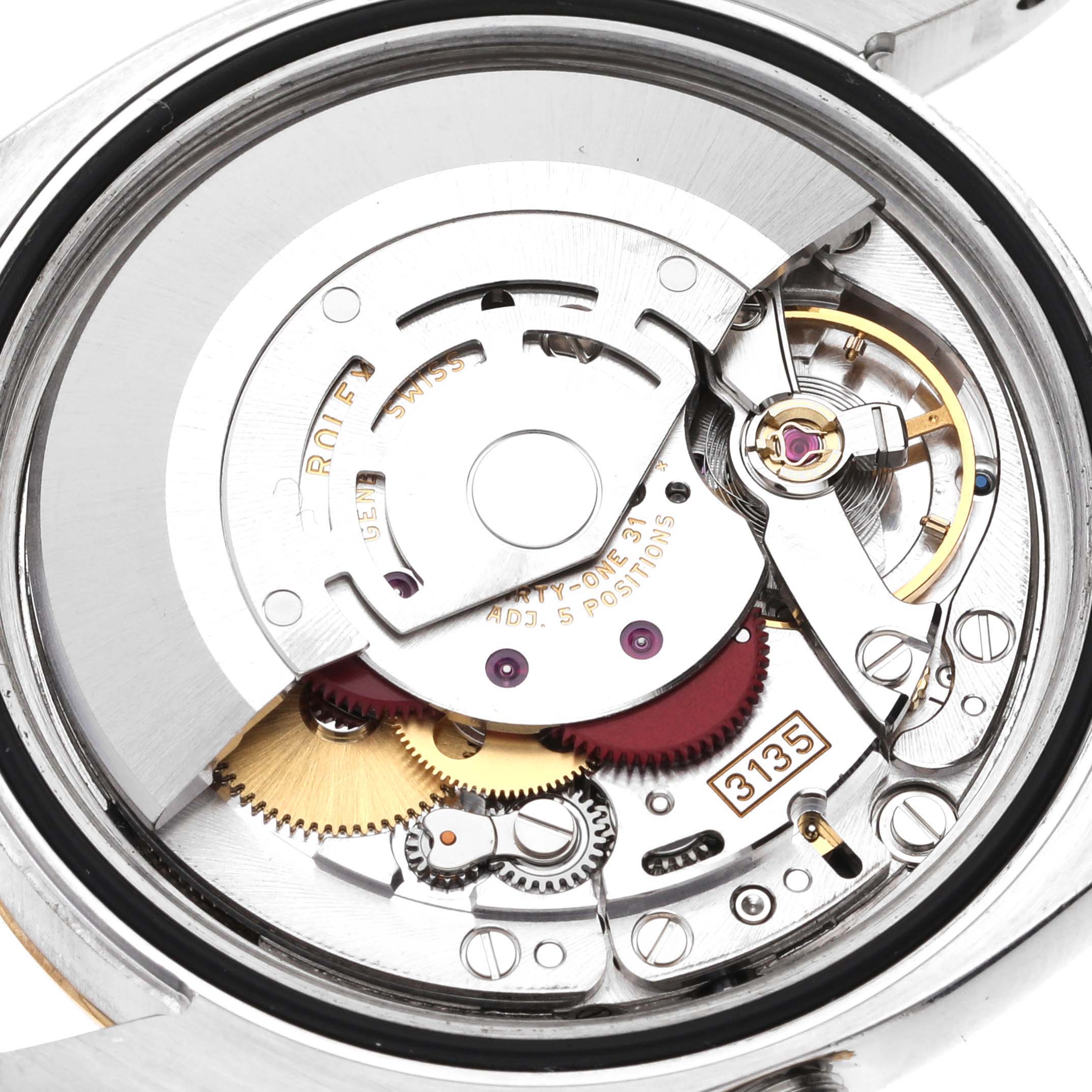 The image shows the internal mechanism of a Rolex Datejust 116233 Men's Stainless Steel Black Dial 116233 Men's Stainless Steel Black Dial watch from a close-up, top-down angle, highlighting gears and movement components.