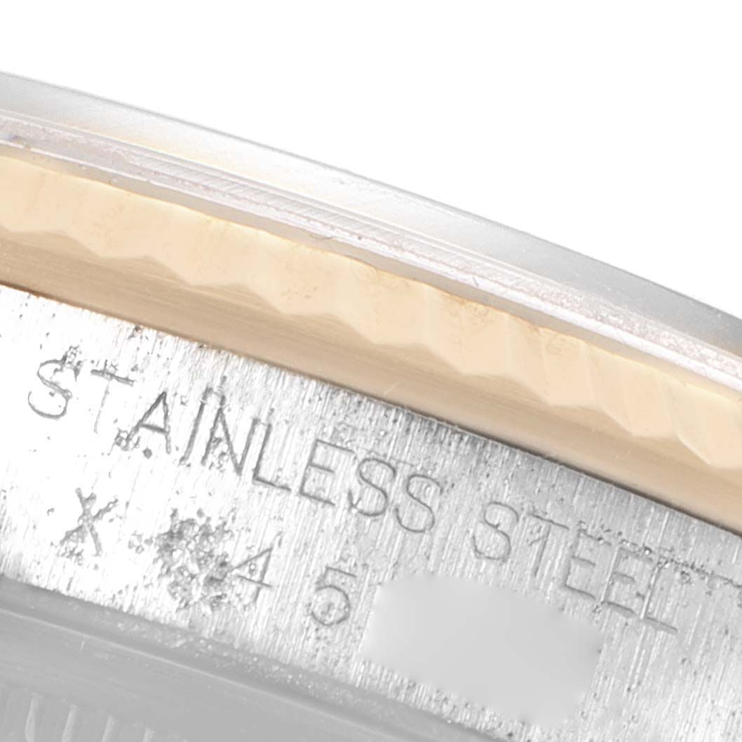 This close-up shows part of the bezel and the engraved text on the case of a Rolex Datejust 16233 Men's Steel and Gold (two tone) Champagne Dial 16233 Men's Steel and Gold (two tone) Champagne Dial watch.