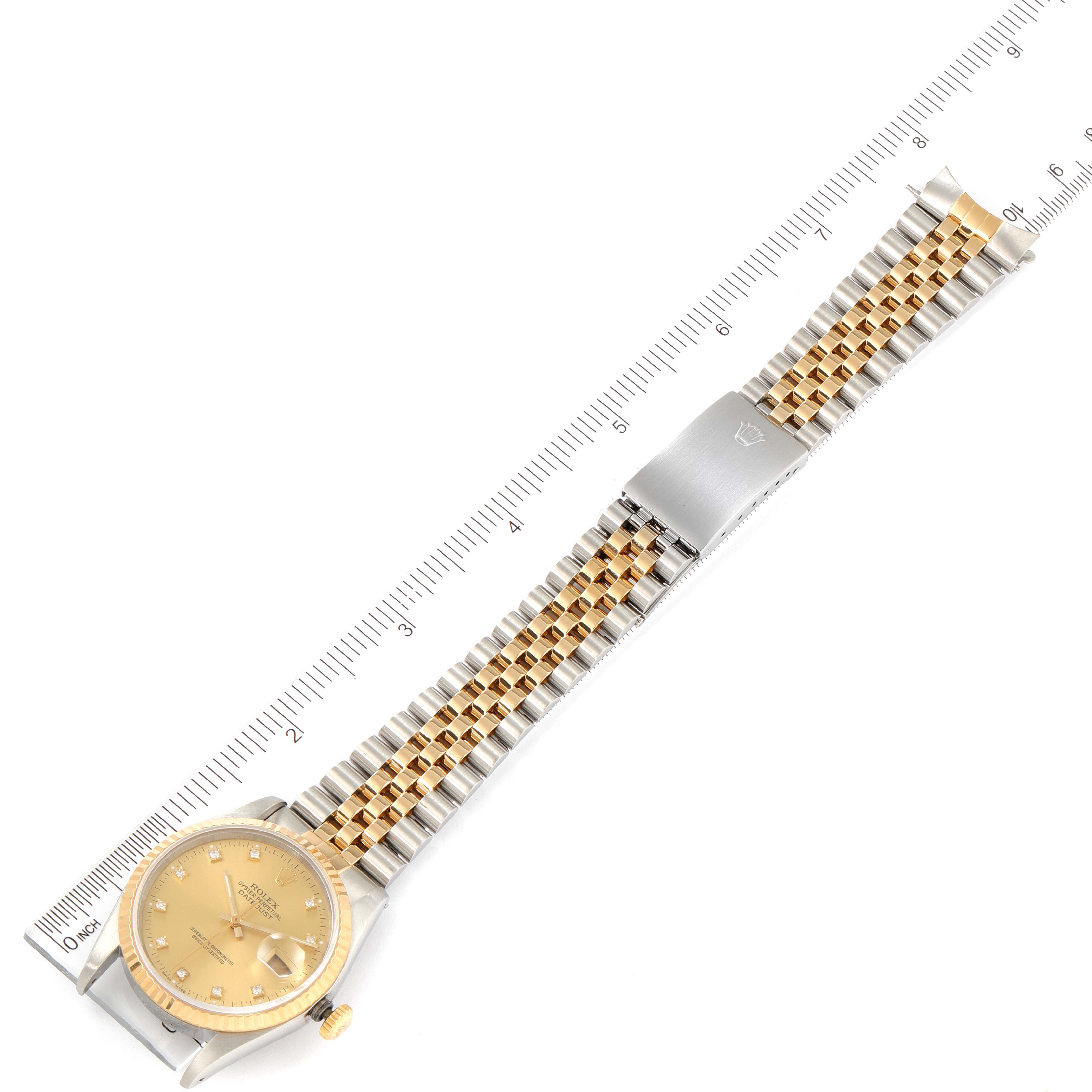 The image shows a top-down view of the Rolex Datejust 16233 Men's Steel and Gold (two tone) Champagne Dial 16233 Men's Steel and Gold (two tone) Champagne Dial watch including the face, bracelet, and clasp, alongside a ruler for size reference.