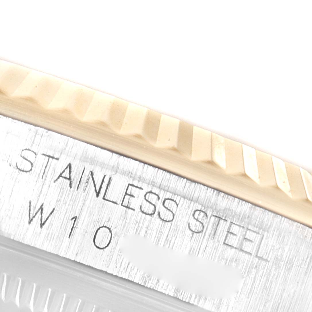 A close-up of the Rolex Datejust 16233 Men
s Steel and Gold (two tone) Champagne Dial 16233 Men
s Steel and Gold (two tone) Champagne Dial watch showing part of the bezel and the engraved case back.