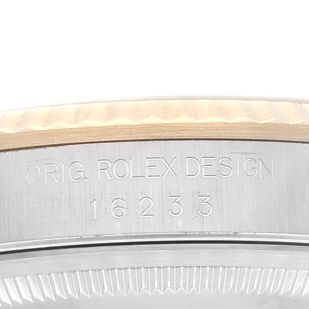 This image shows a close-up of the side case and bezel of the Rolex Datejust 16233 Men's Steel and Gold (two tone) Champagne Dial 16233 Men's Steel and Gold (two tone) Champagne Dial model, engraved with "ORIG. ROLEX DESIGN 16233".