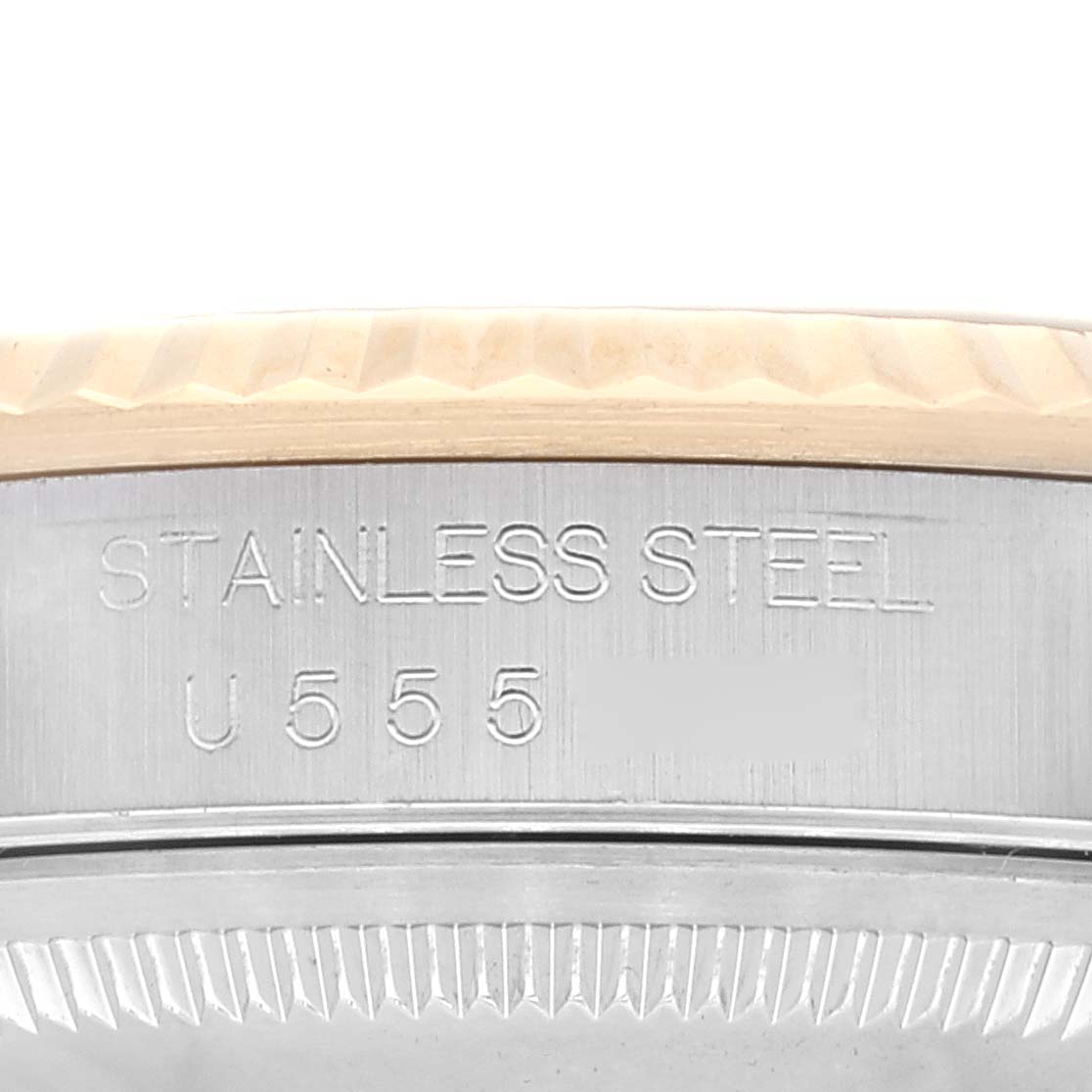 The image shows part of the stainless steel case and fluted bezel of a Rolex Datejust 16233 Men's Steel and Gold (two tone) Champagne Dial 16233 Men's Steel and Gold (two tone) Champagne Dial watch.