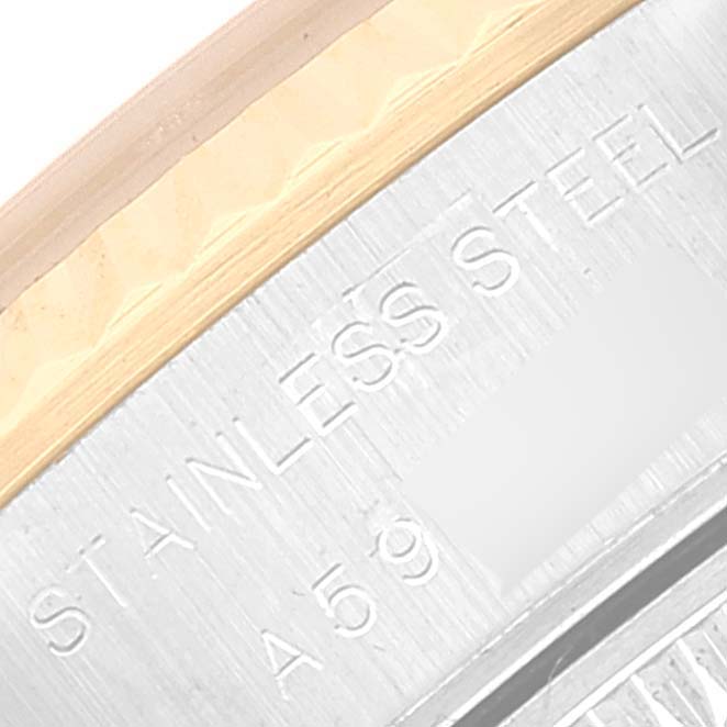 This image shows a close-up of the stainless steel case of a Rolex Datejust 79173 Women's Steel and Gold (two tone) Champagne Dial 79173 Women's Steel and Gold (two tone) Champagne Dial watch, featuring part of the bezel and engraved text.