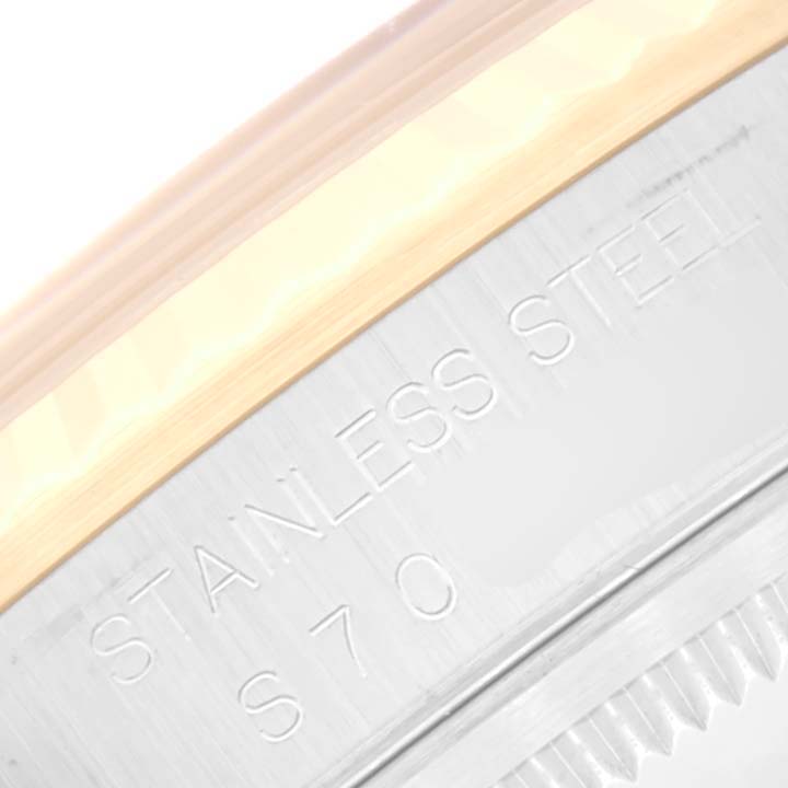The image shows a close-up of the side engraving on the stainless steel case, near the bezel, of a Rolex Datejust 16233 Men's Steel and Gold (two tone) Champagne Dial 16233 Men's Steel and Gold (two tone) Champagne Dial watch.