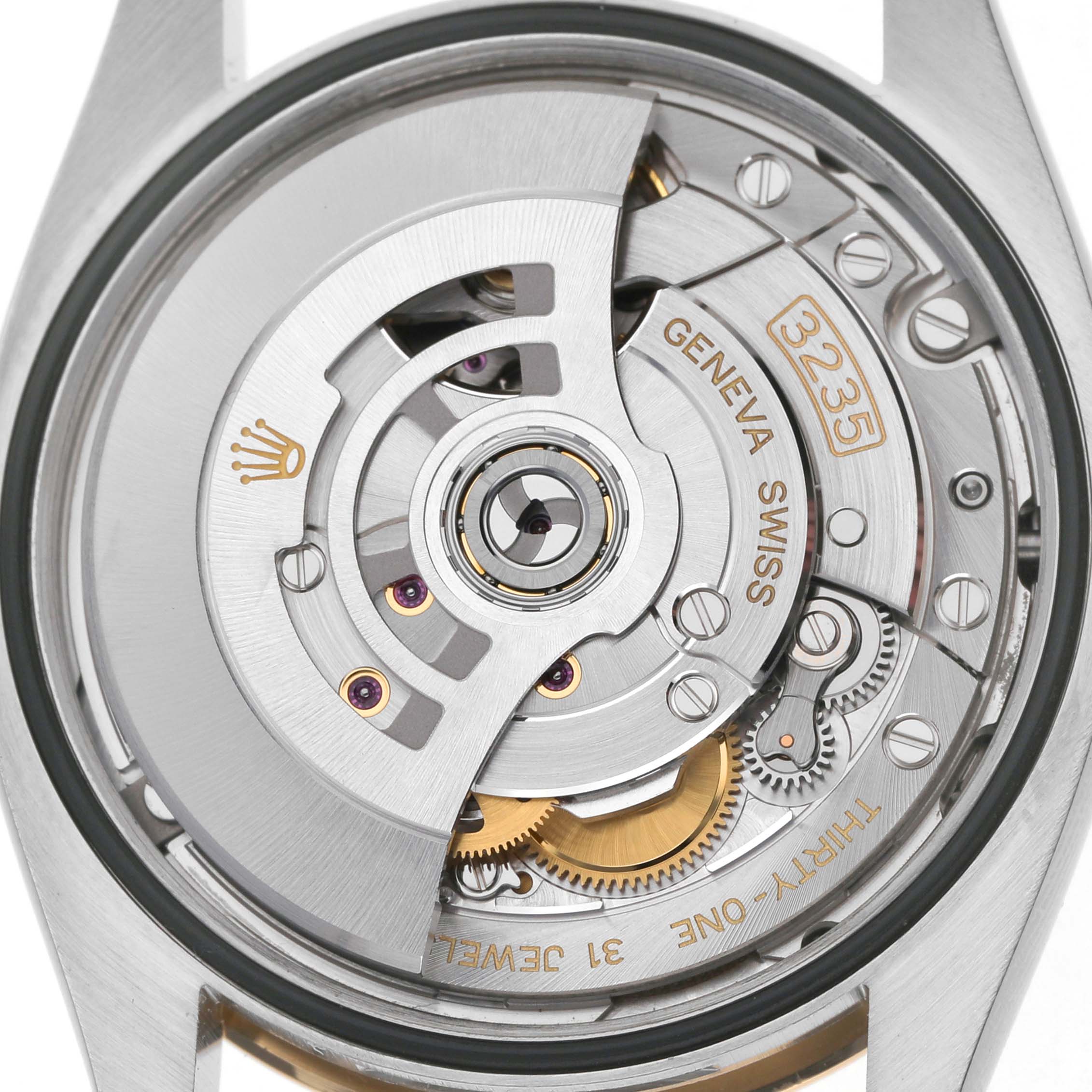 The image shows the Rolex Datejust 126233 Men's Steel and Gold (two tone) Silver Dial's movement from a back angle, highlighting the intricate gears and rotor.