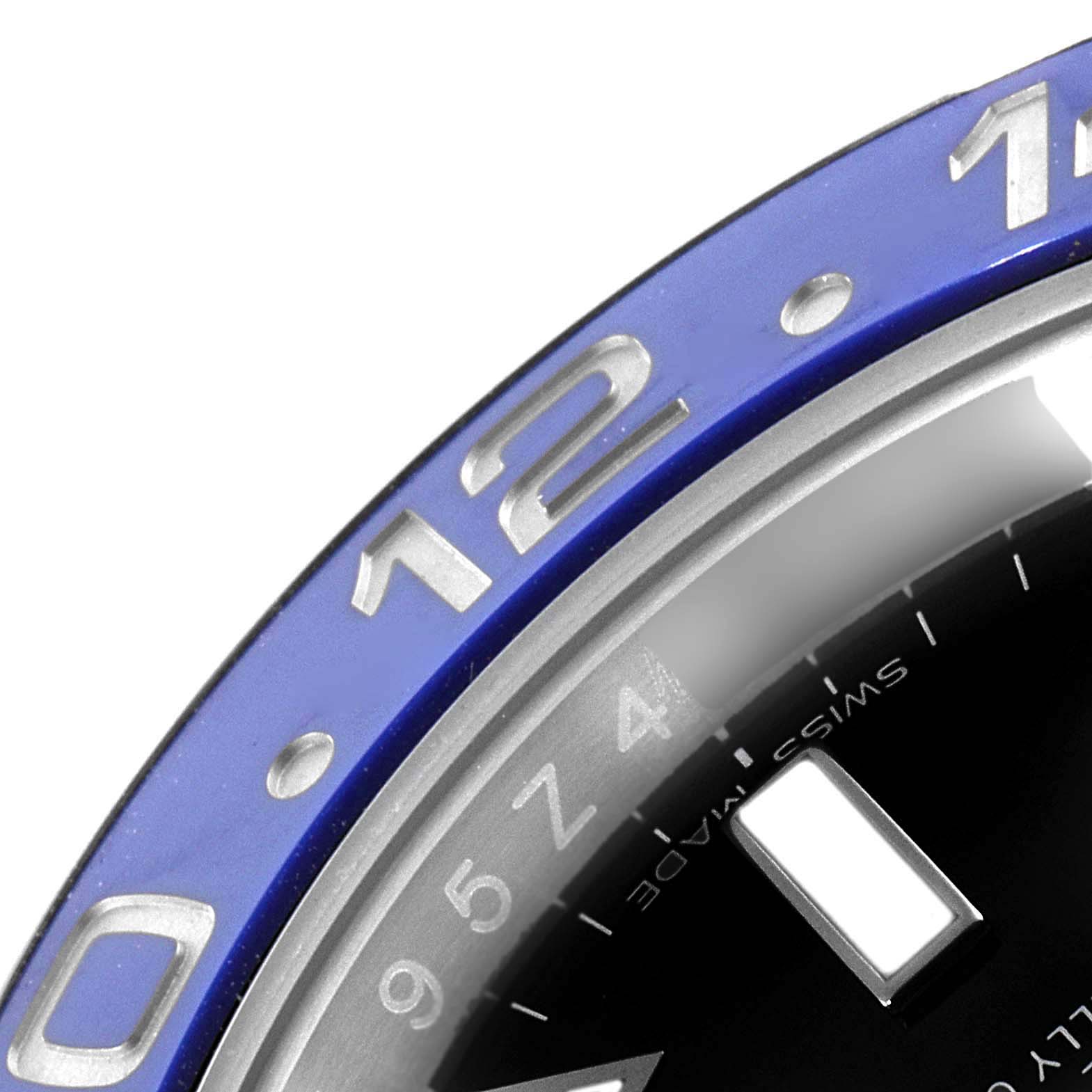 The image shows a close-up view of the bezel and part of the dial of a Rolex GMT-Master 116710BLNR Men's Stainless Steel Black Dial 116710BLNR Men's Stainless Steel Black Dial watch.