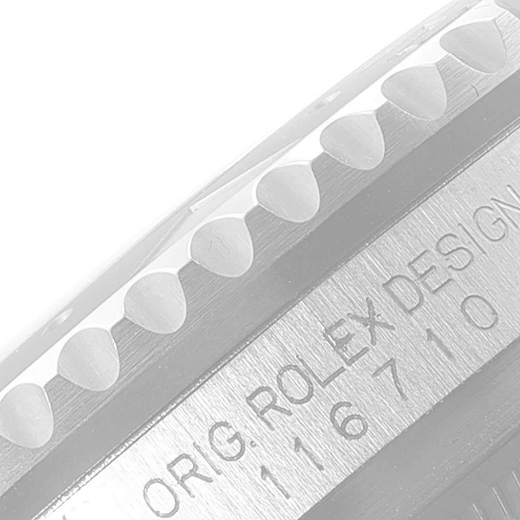 The image shows a close-up of the Rolex GMT-Master 116710BLNR Men's Stainless Steel Black Dial 116710BLNR Men's Stainless Steel Black Dial watch bezel and case with model and "ORIG. ROLEX DESIGN" engraved.