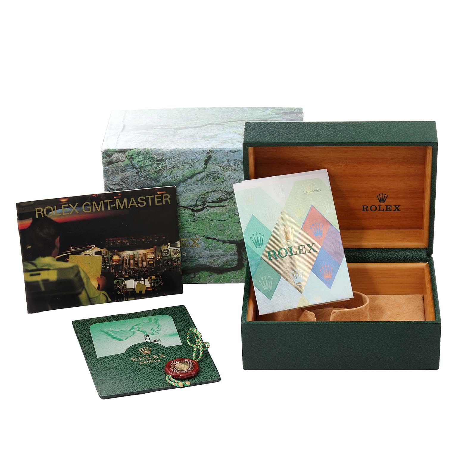 This image shows the packaging and accessories of a Rolex GMT-Master 16710 Men
s Stainless Steel Black Dial 16710 Men
s Stainless Steel Black Dial, including the box, manual, and warranty card.