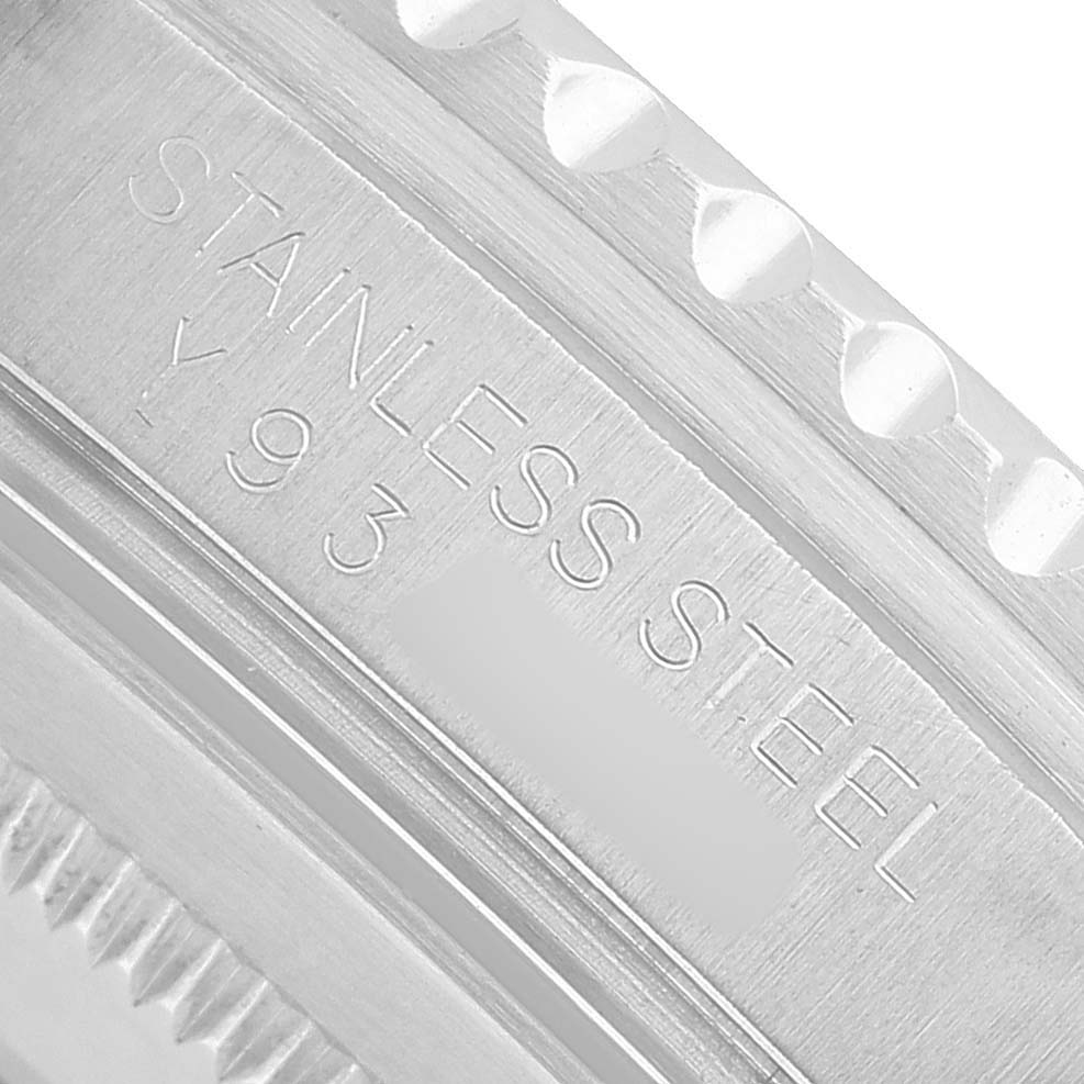 The image shows a close-up of the stainless steel bezel of a Rolex GMT-Master 16710 Men's Stainless Steel Black Dial watch, featuring engraved text.