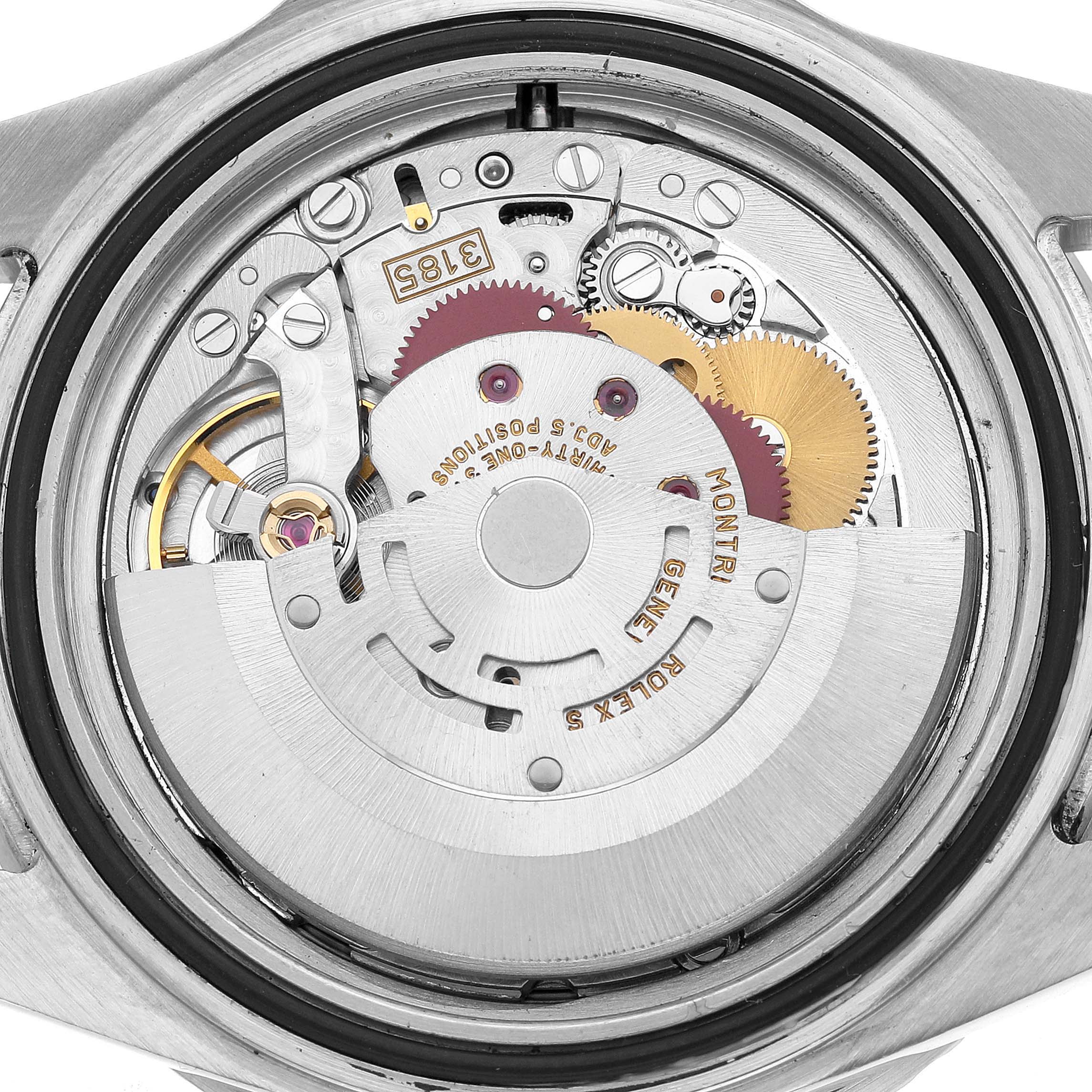 The image shows a close-up of the movement mechanism of a Rolex GMT-Master 16710 Men's Stainless Steel Black Dial, highlighting gears and components.