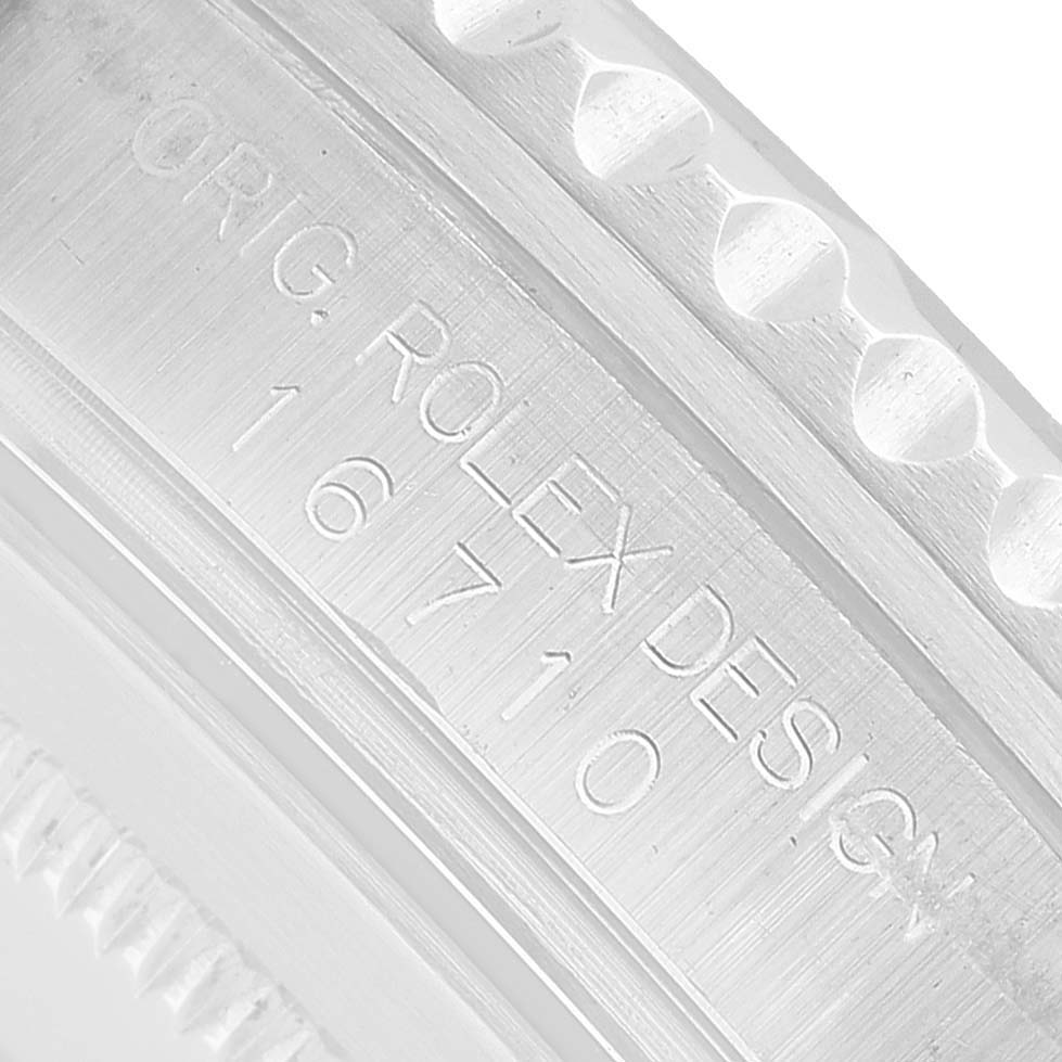 The image shows a close-up of the engraved inner bezel of a Rolex GMT-Master 16710 Men's Stainless Steel Black Dial, displaying the model number 16710.