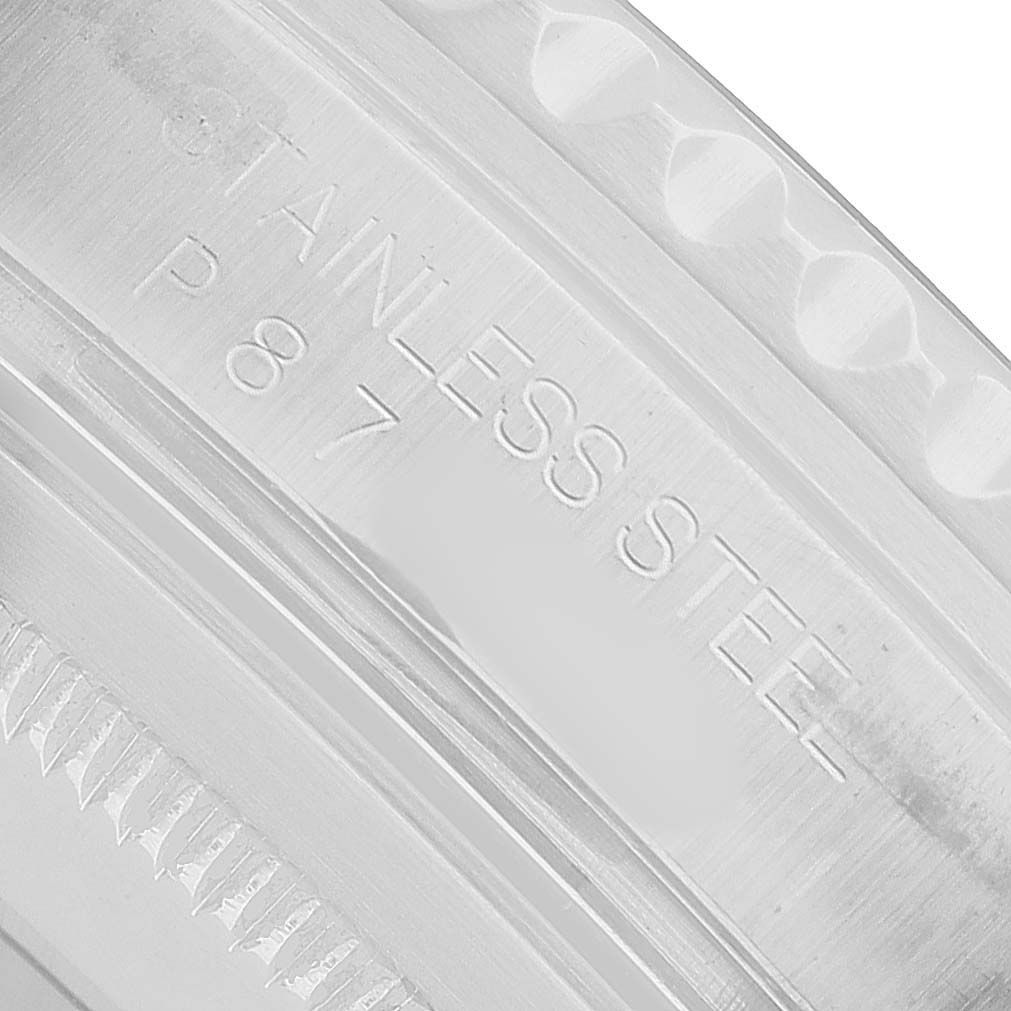 The image shows a close-up of the caseback edge of a Rolex GMT-Master 16710 Men's Stainless Steel Black Dial, highlighting the "STAINLESS STEEL" engraving.