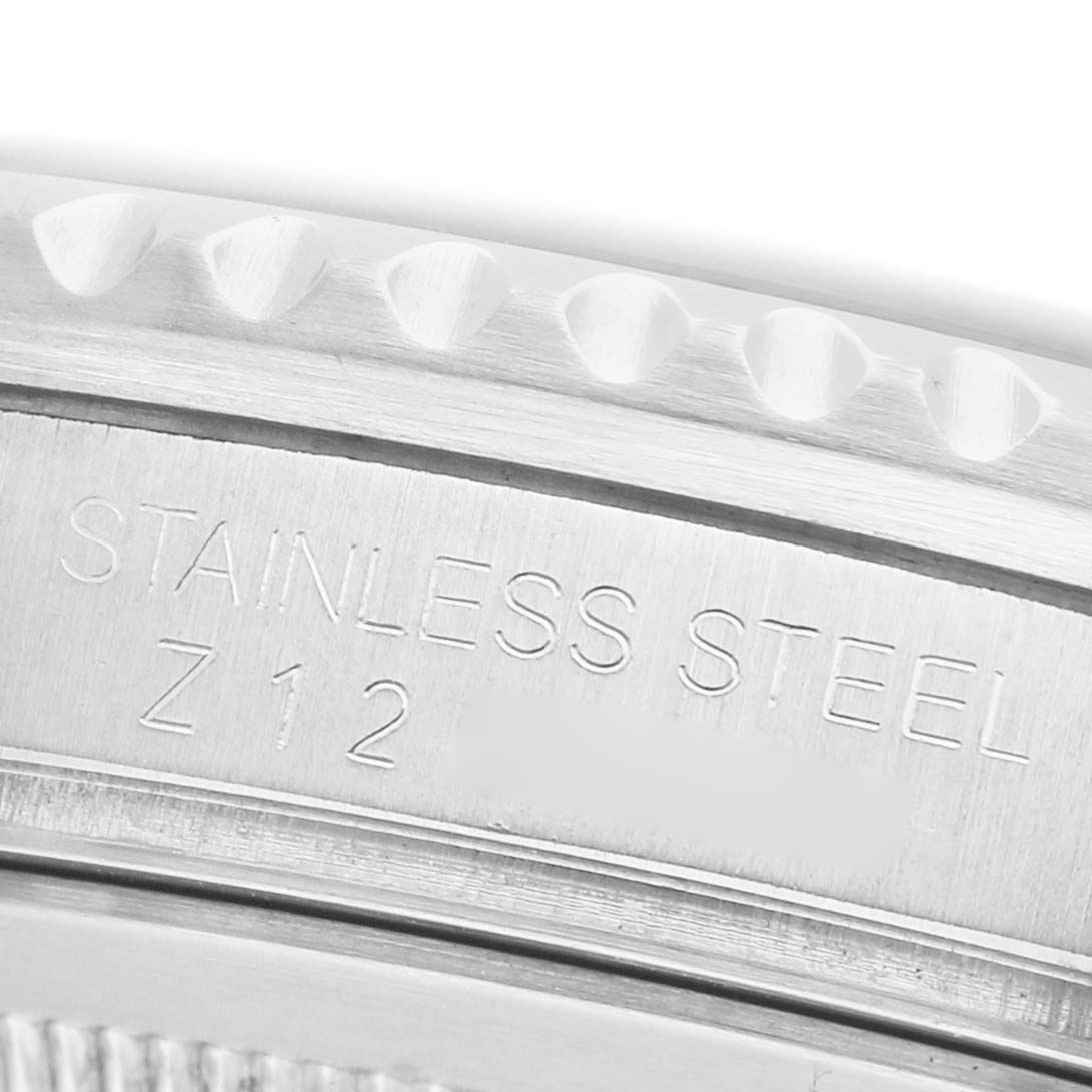 The image shows a close-up of the Rolex GMT-Master 16710 Men's Stainless Steel Black Dial's engraved stainless steel case edge.