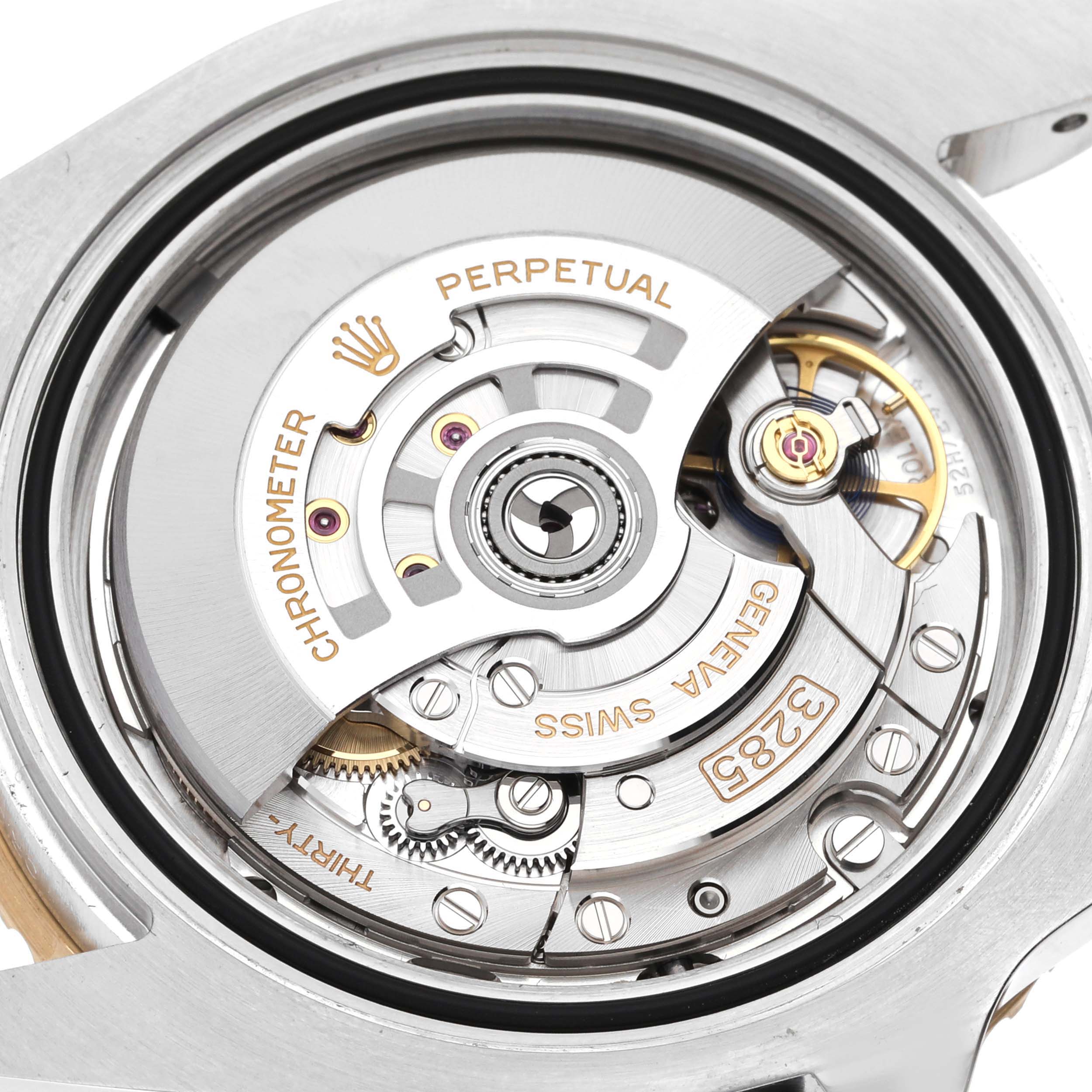 The image shows the inner mechanism of a Rolex GMT-Master 126713 Men's Steel and Gold (two tone) Black Dial 126713 Men's Steel and Gold (two tone) Black Dial, focusing on its movement and gears from the back.