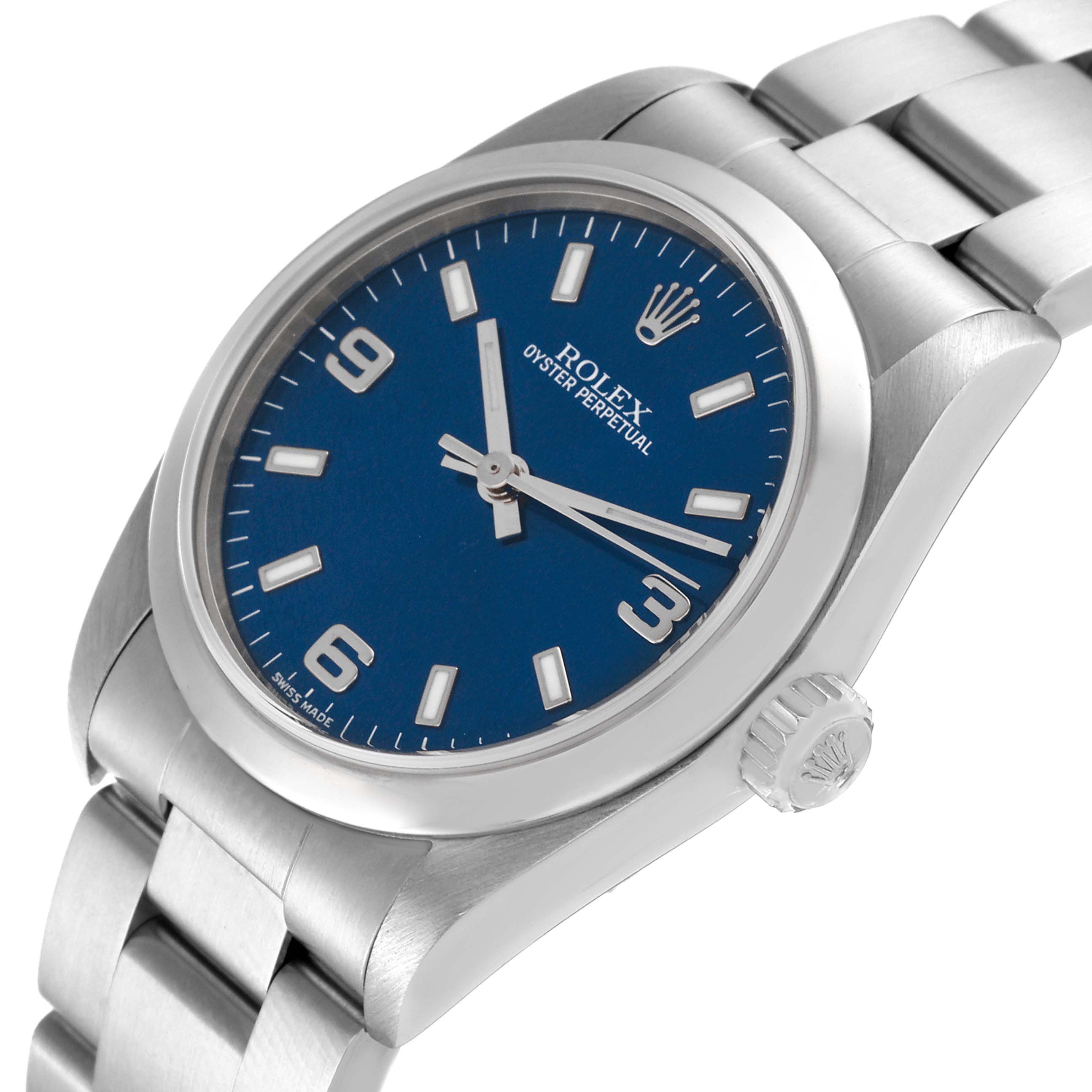 The image shows a side angle of a Rolex Oyster Perpetual Mid-Size, highlighting the blue dial, crown, and part of the metal bracelet.