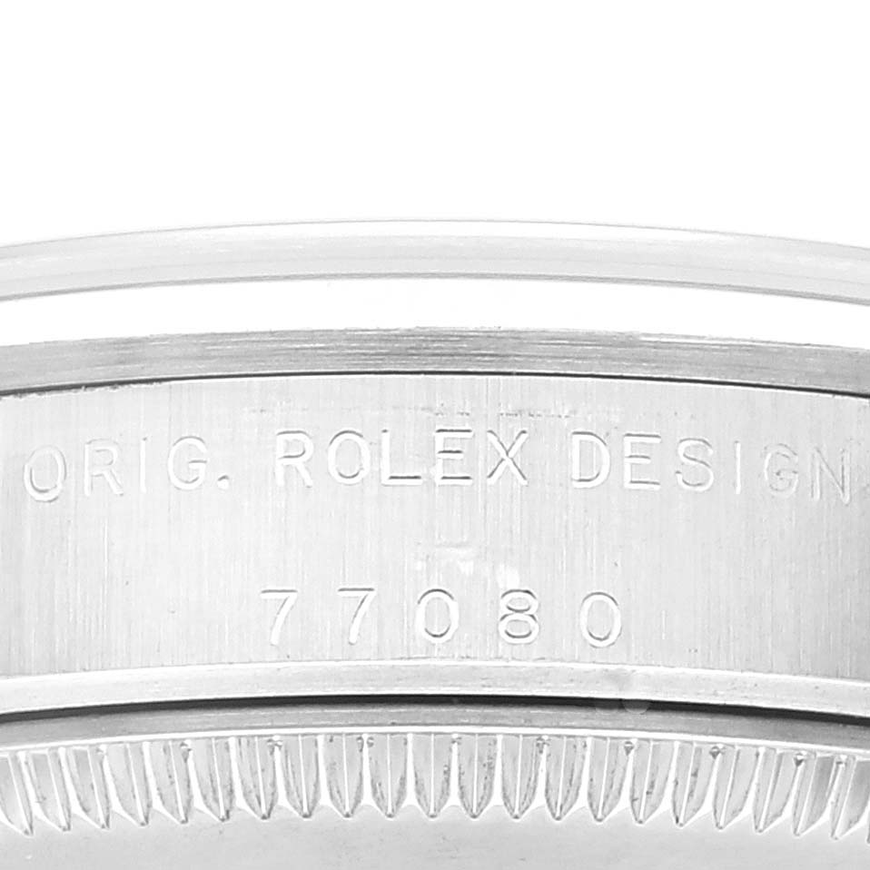This image shows a side view of a Rolex Mid-Size 77080 Women's Stainless Steel Blue Dial 77080 Women's Stainless Steel Blue Dial model watch case with the "Orig. Rolex Design" and model number 77080 engraved.
