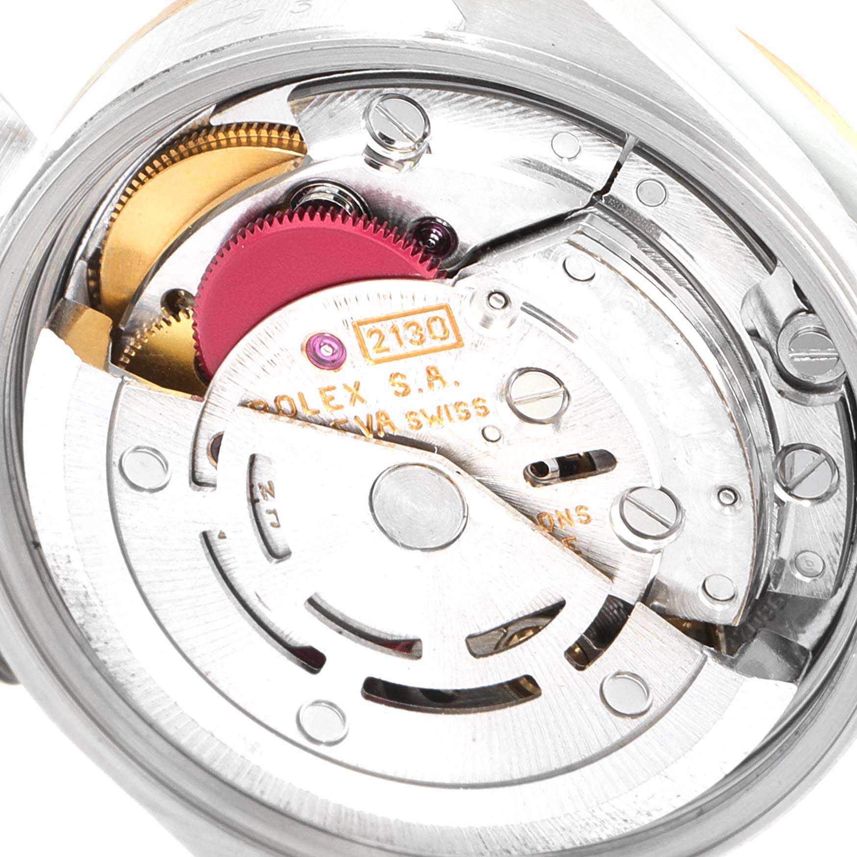 The image shows an interior view of the movement mechanism of a Rolex Oyster Perpetual 67193 Women's Steel and Gold (two tone) White Dial 67193 Women's Steel and Gold (two tone) White Dial watch, highlighting gears and inscriptions.
