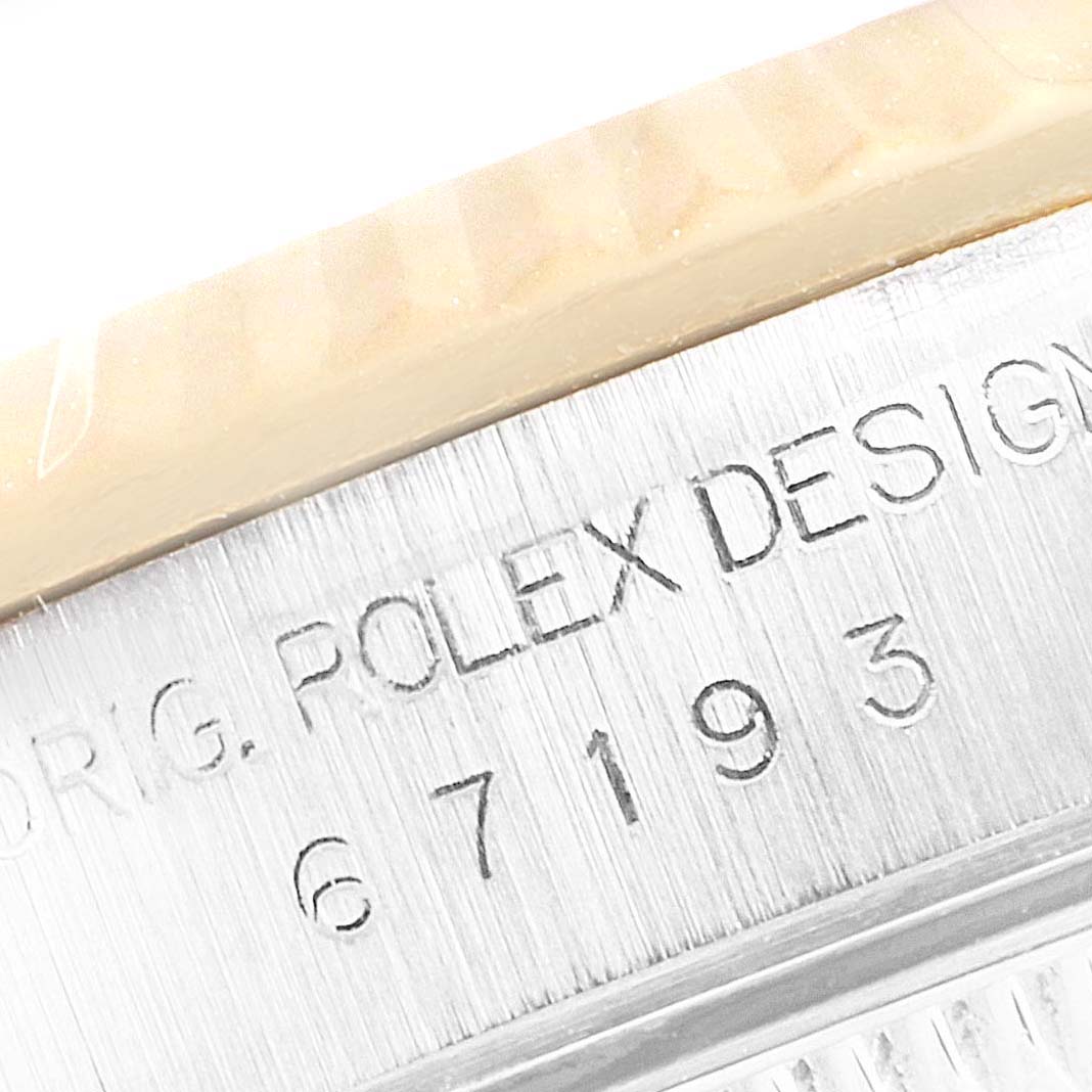 This close-up image shows the serial number engraving on the side of a Rolex Oyster Perpetual 67193 Women's Steel and Gold (two tone) White Dial 67193 Women's Steel and Gold (two tone) White Dial watch case.