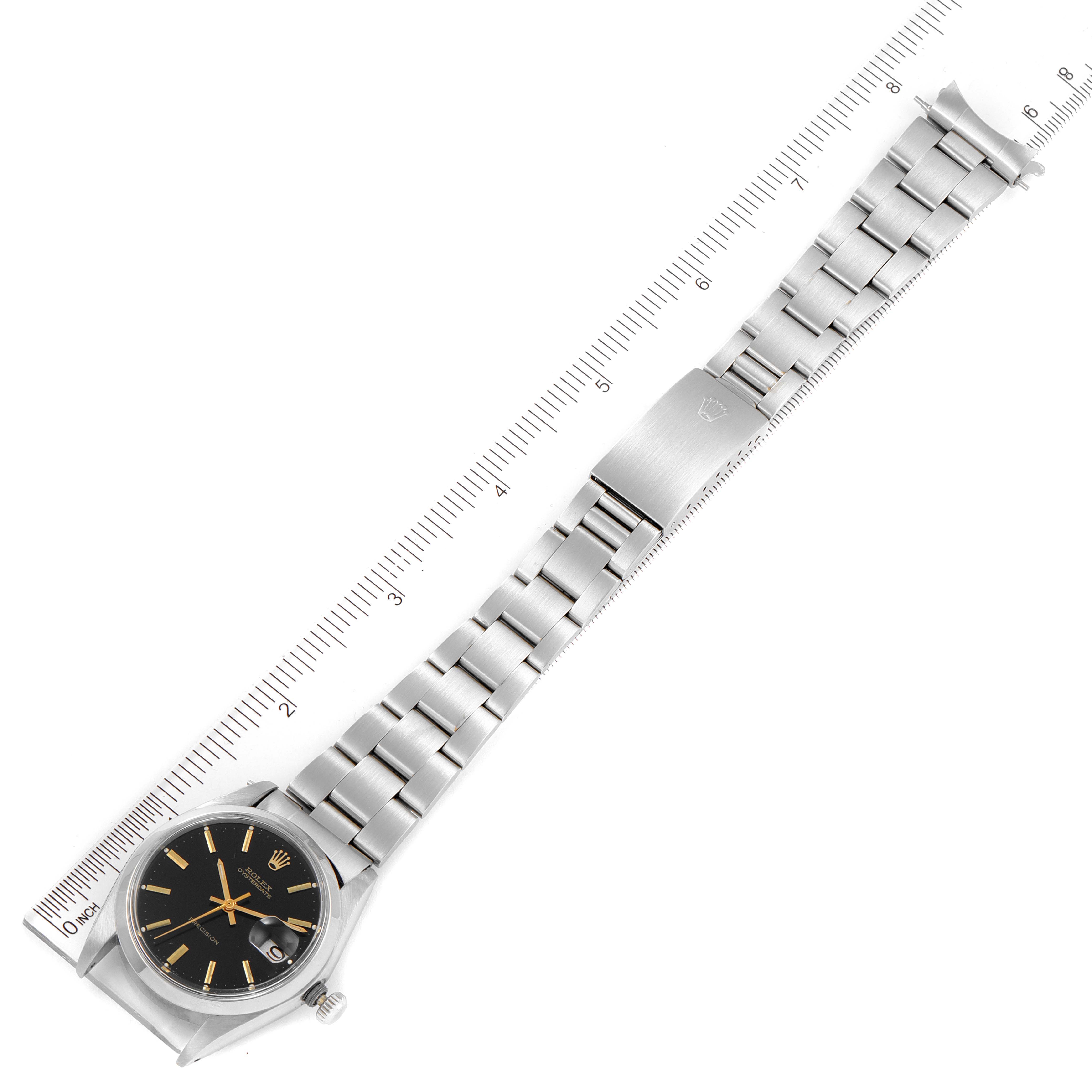 The image shows the full length of a Rolex Vintage Collection 6694 Men's Stainless Steel Black Dial 6694 Men's Stainless Steel Black Dial watch, including the face and the entire stainless steel bracelet with a ruler for measurement.