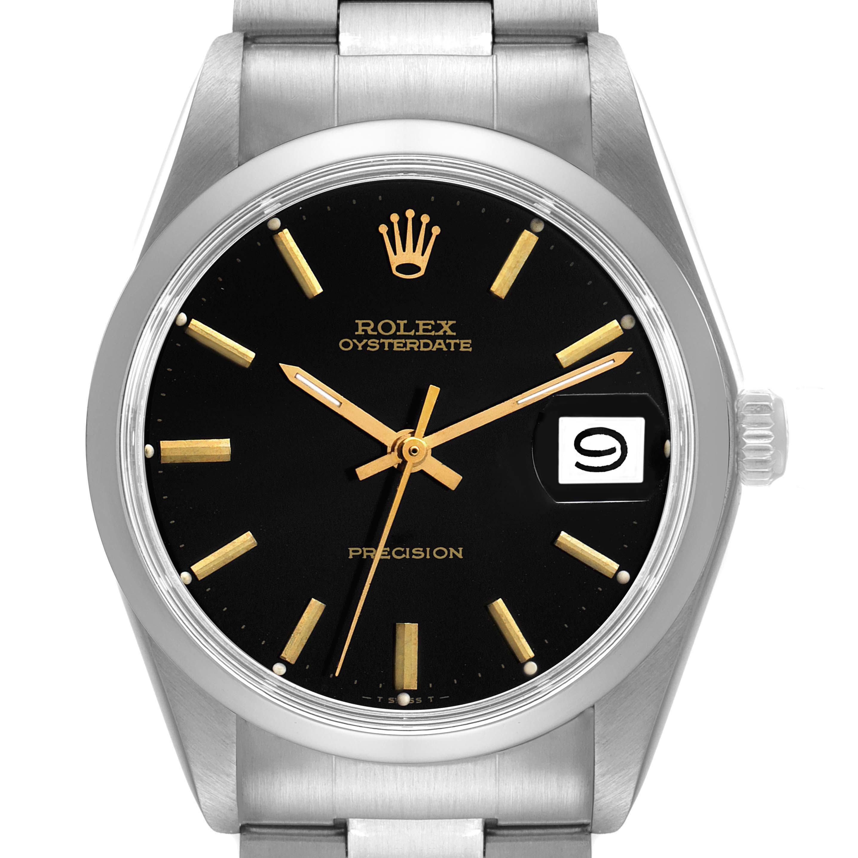 The image shows a frontal view of the Rolex Vintage Collection 6694 Men's Stainless Steel Black Dial 6694 Men's Stainless Steel Black Dial model, displaying its black dial, gold markers, and date window.
