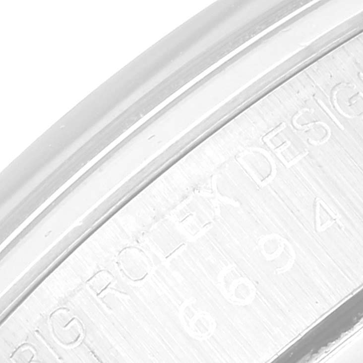 The image shows a close-up of the side of a Rolex Vintage Collection 6694 Men
s Stainless Steel Silver Dial 6694 Men
s Stainless Steel Silver Dial watch, highlighting the engraved "ROLEX DESIGN" text.