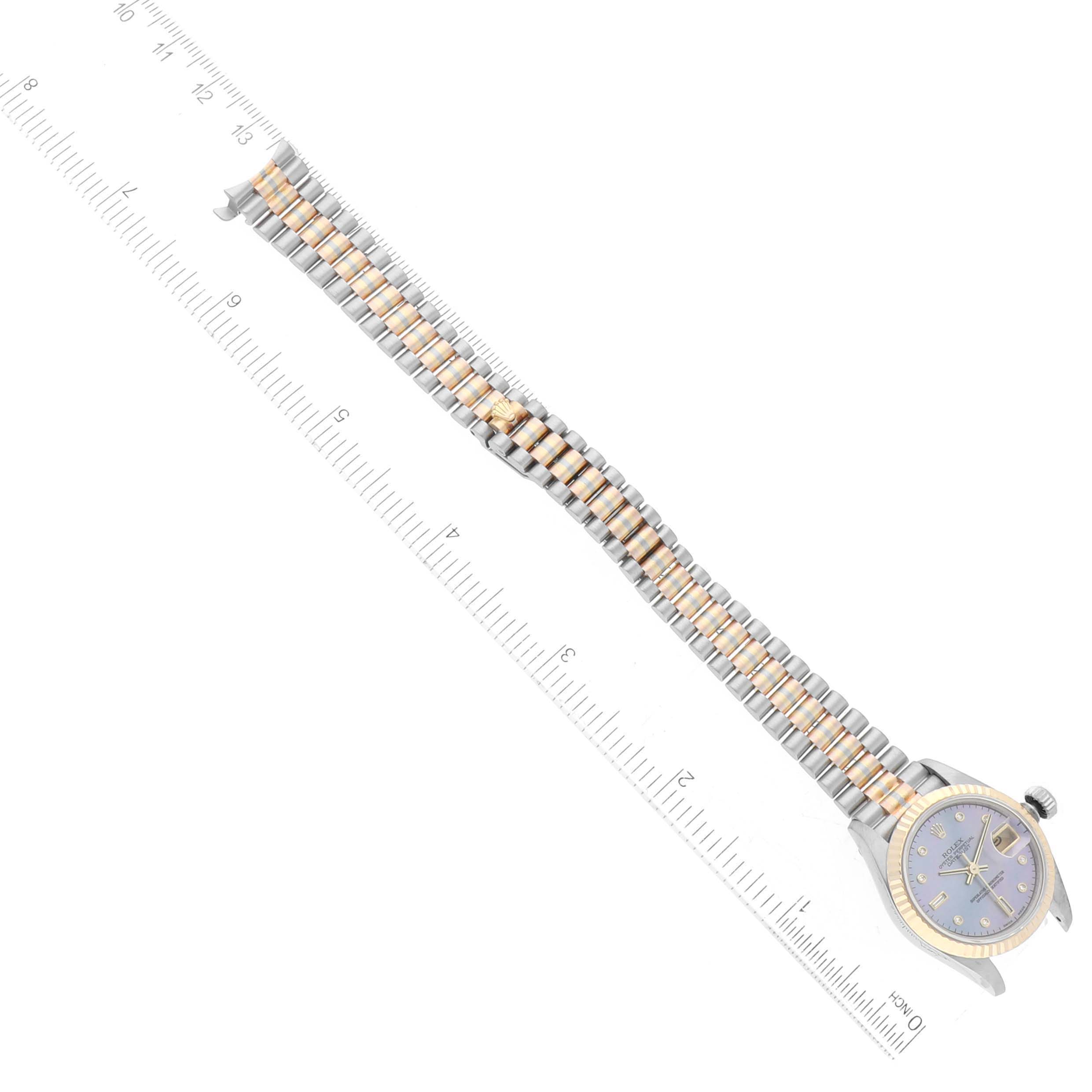 The Rolex President 69179 Women's White Gold Mother of Pearl Dial 69179 Women's White Gold Mother of Pearl Dial model watch is shown from a top-down angle, displaying the face, case, and full bracelet next to a measuring ruler.