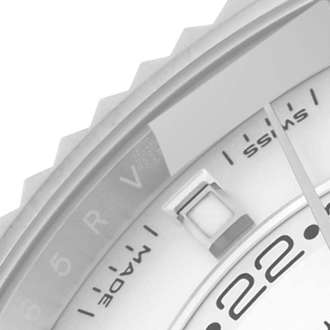 This close-up shows the bezel, part of the dial, and a small window of a Rolex Sky-Dweller 326934 Men's Stainless Steel Silver Dial 326934 Men's Stainless Steel Silver Dial watch.