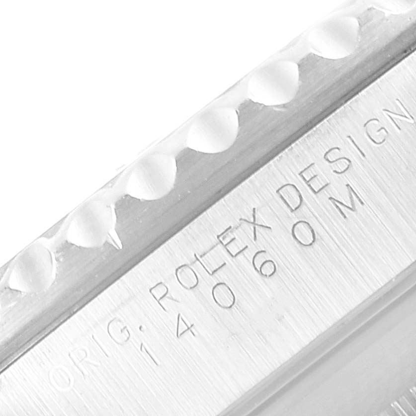 The image shows a close-up of the Rolex Submariner 14060 Men's Stainless Steel Black Dial 14060 Men's Stainless Steel Black Dial's bezel and engraved casing details.