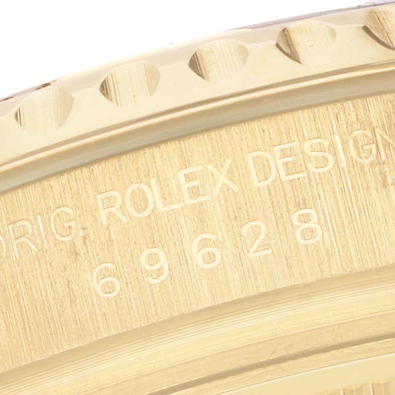 The image shows a close-up of the bezel and case of a Rolex Yacht-Master 69628 Women's Yellow Gold Mother of Pearl Dial 69628 Women's Yellow Gold Mother of Pearl Dial watch, featuring model and brand engravings.