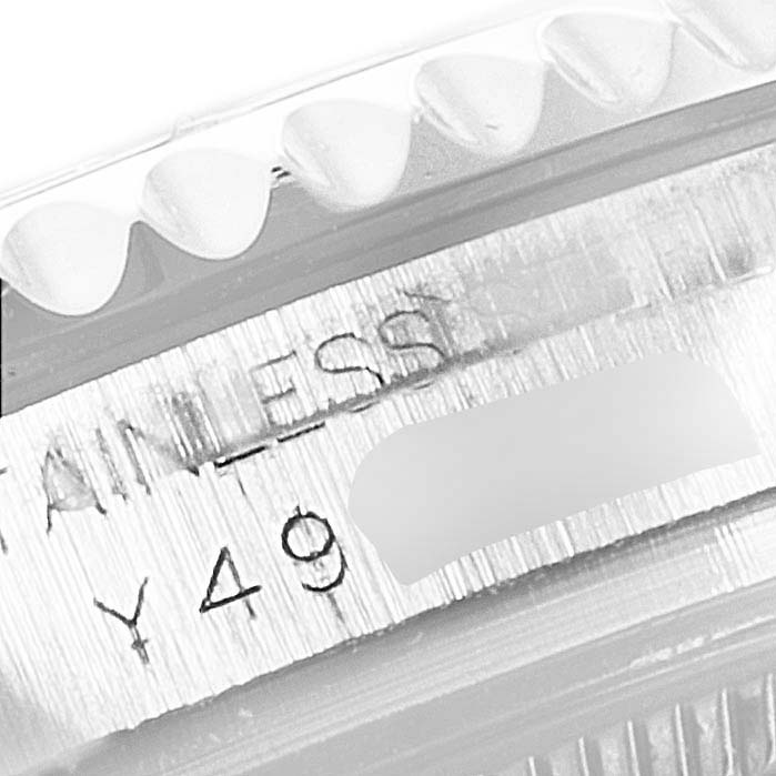 This close-up shows the edge and part of the bezel and case of a Rolex Yacht-Master 168622 Men's Stainless Steel Silver Dial 168622 Men's Stainless Steel Silver Dial watch with engraved text.