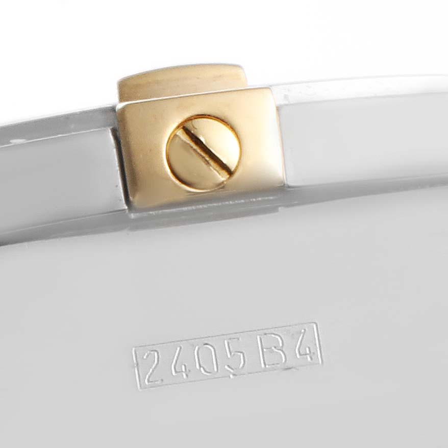 The image shows a close-up of the screw and part of the case back of a Breitling Chronomat B13356 Men's Steel and Gold (two tone) Black Dial B13356 Men's Steel and Gold (two tone) Black Dial watch, with a serial number engraved.