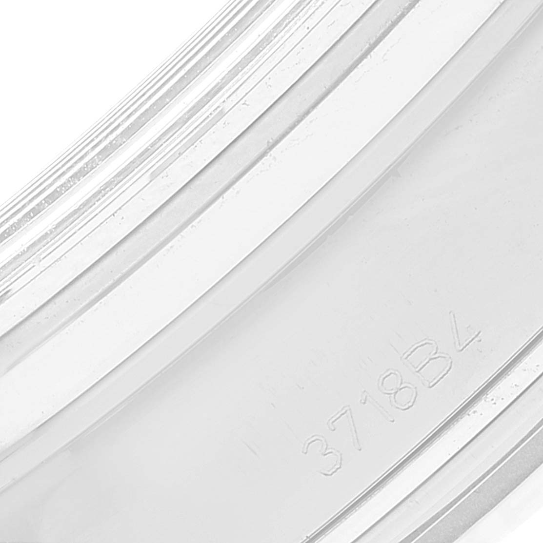 This image shows a close-up of the case back's edge of a Breitling Premier AB0118221G1P2 Men's Stainless Steel Silver Dial AB0118221G1P2 Men's Stainless Steel Silver Dial watch, featuring an engraved code "3718B4."