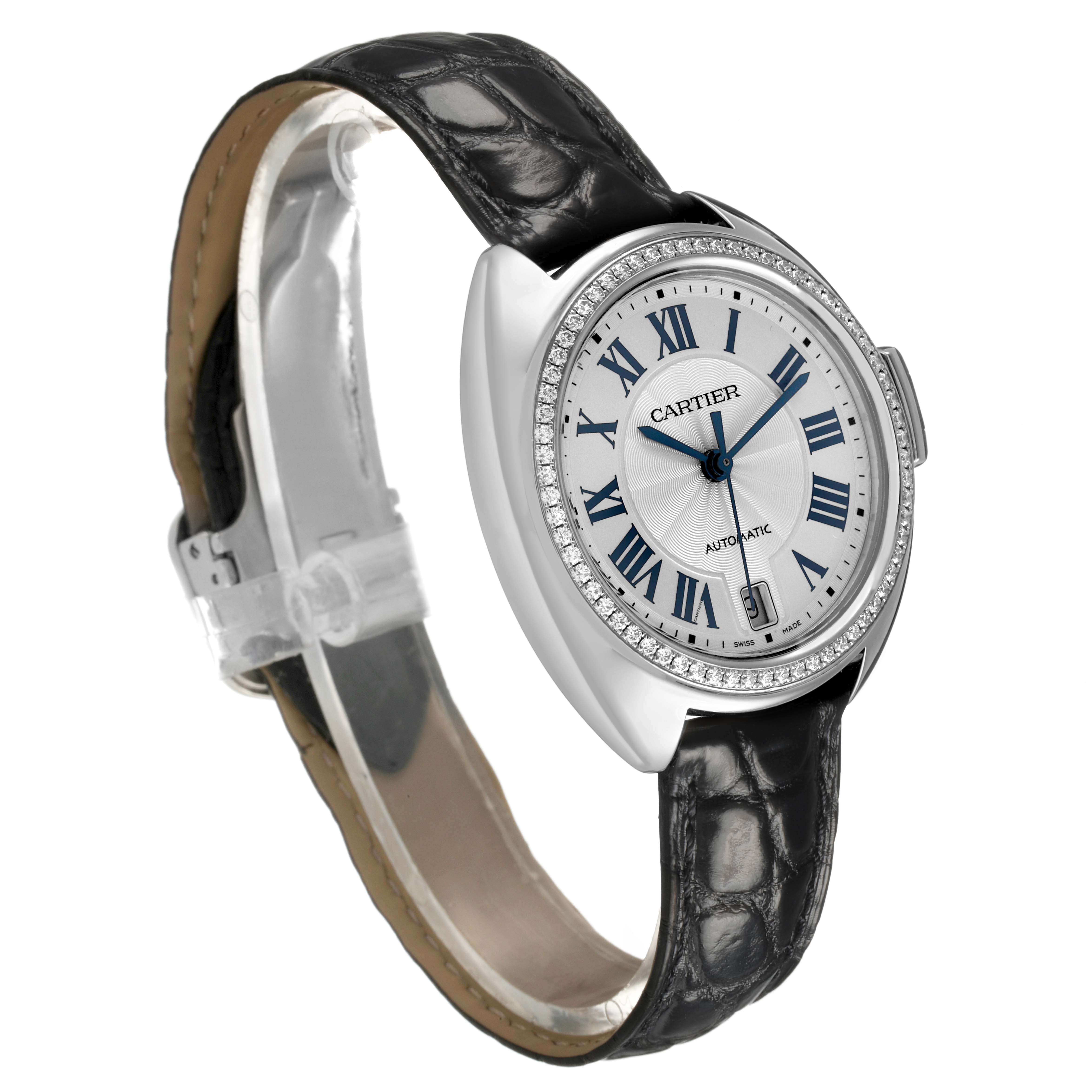 The Cartier Clé watch is shown at a slight angle, revealing the dial, bezel, crown, and leather strap clearly.