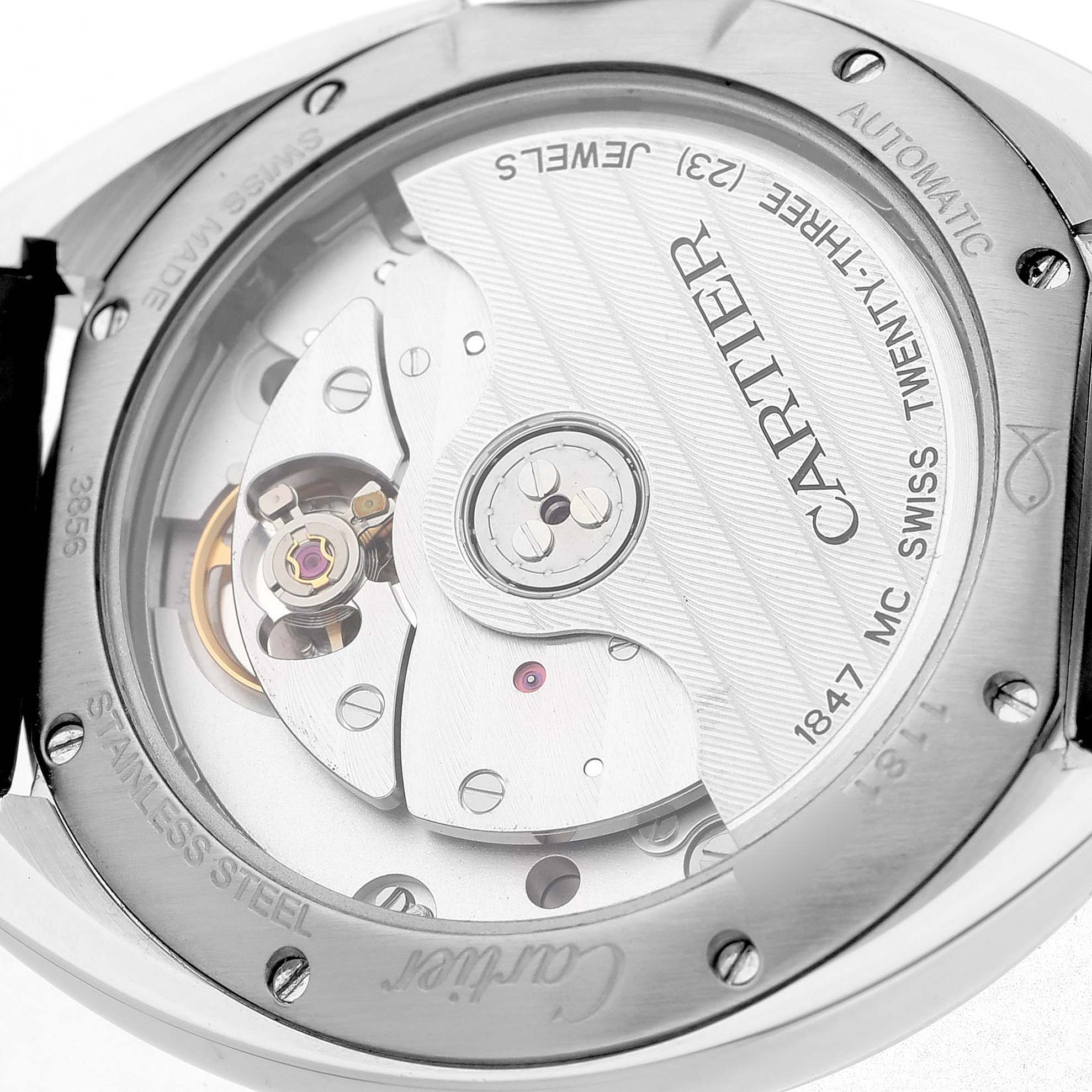 The image shows the back of a Cartier Clé watch, revealing its automatic movement and internal mechanisms.