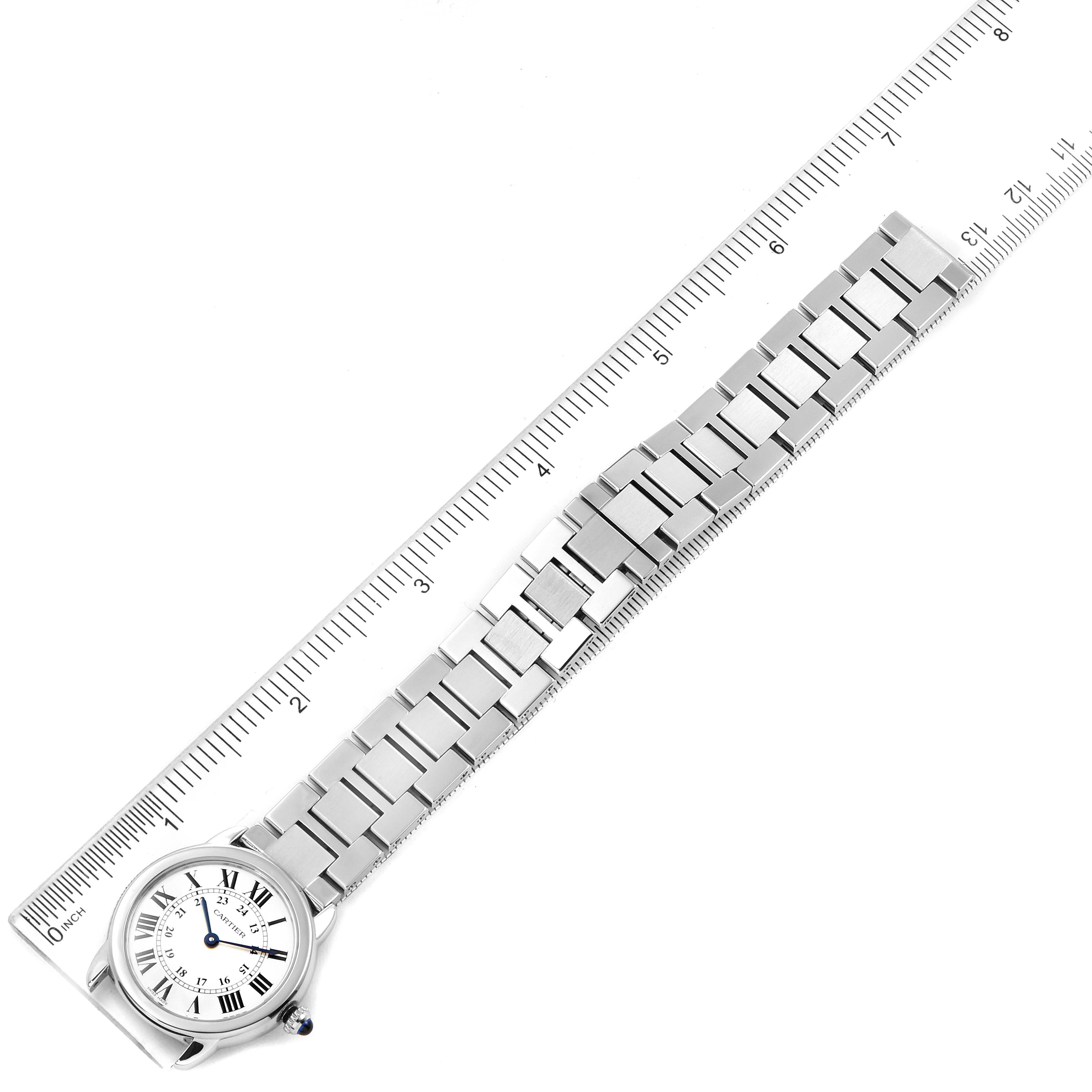 The image shows the Cartier Ronde W6701004 Women's Stainless Steel Silver Dial W6701004 Women's Stainless Steel Silver Dial watch face and bracelet laid flat with a ruler for scale.