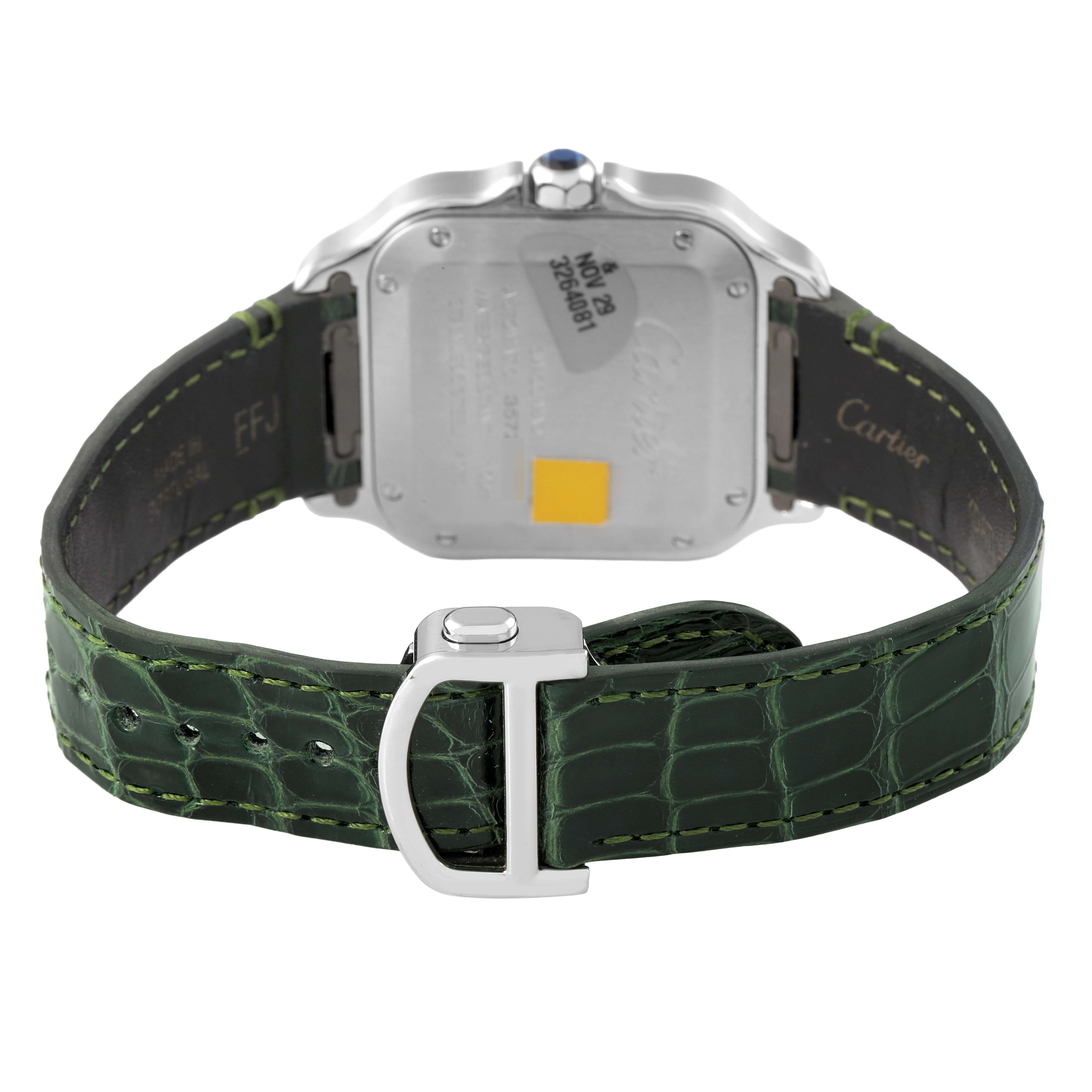 The image shows the back of a Cartier Santos WSSA0061 Men's Stainless Steel Green Dial watch, highlighting the case back, crown, and green leather strap with a buckle.