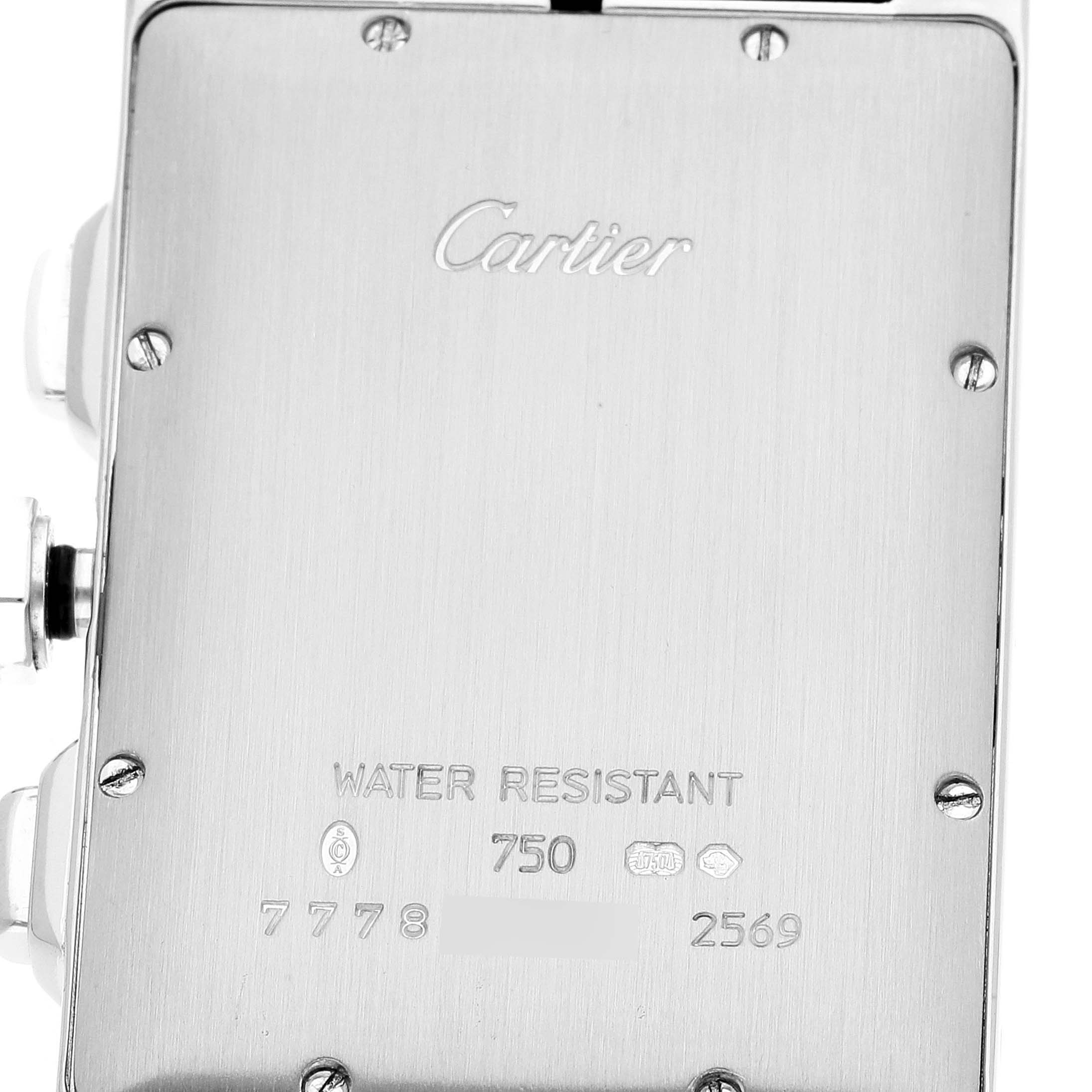 The image shows the back case of a Cartier Tank Americaine W2605956 Men's White Gold Silver Dial W2605956 Men's White Gold Silver Dial watch, featuring engravings and screws.