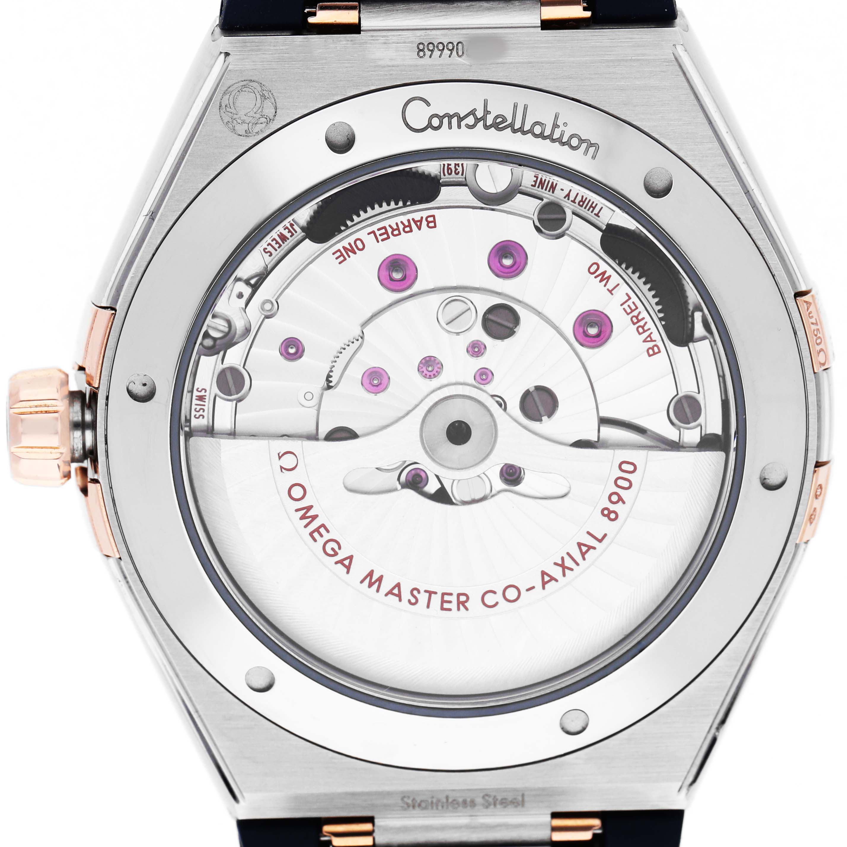 The image shows the back view of the Omega Constellation 131.23.41.21.03.001 Men's Stainless Steel Blue Dial watch, highlighting the movement and inner mechanics.