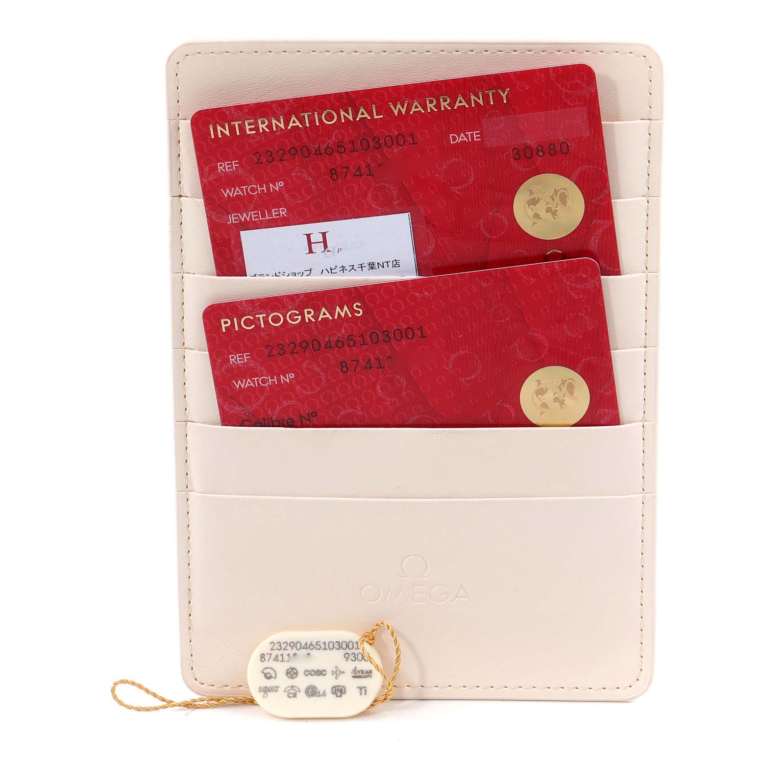 The image shows an Omega Planet Ocean 232.90.46.51.03.001 Men's Titanium Blue Dial 232.90.46.51.03.001 Men's Titanium Blue Dial's international warranty card, pictograms card, and a tag in a beige cardholder.