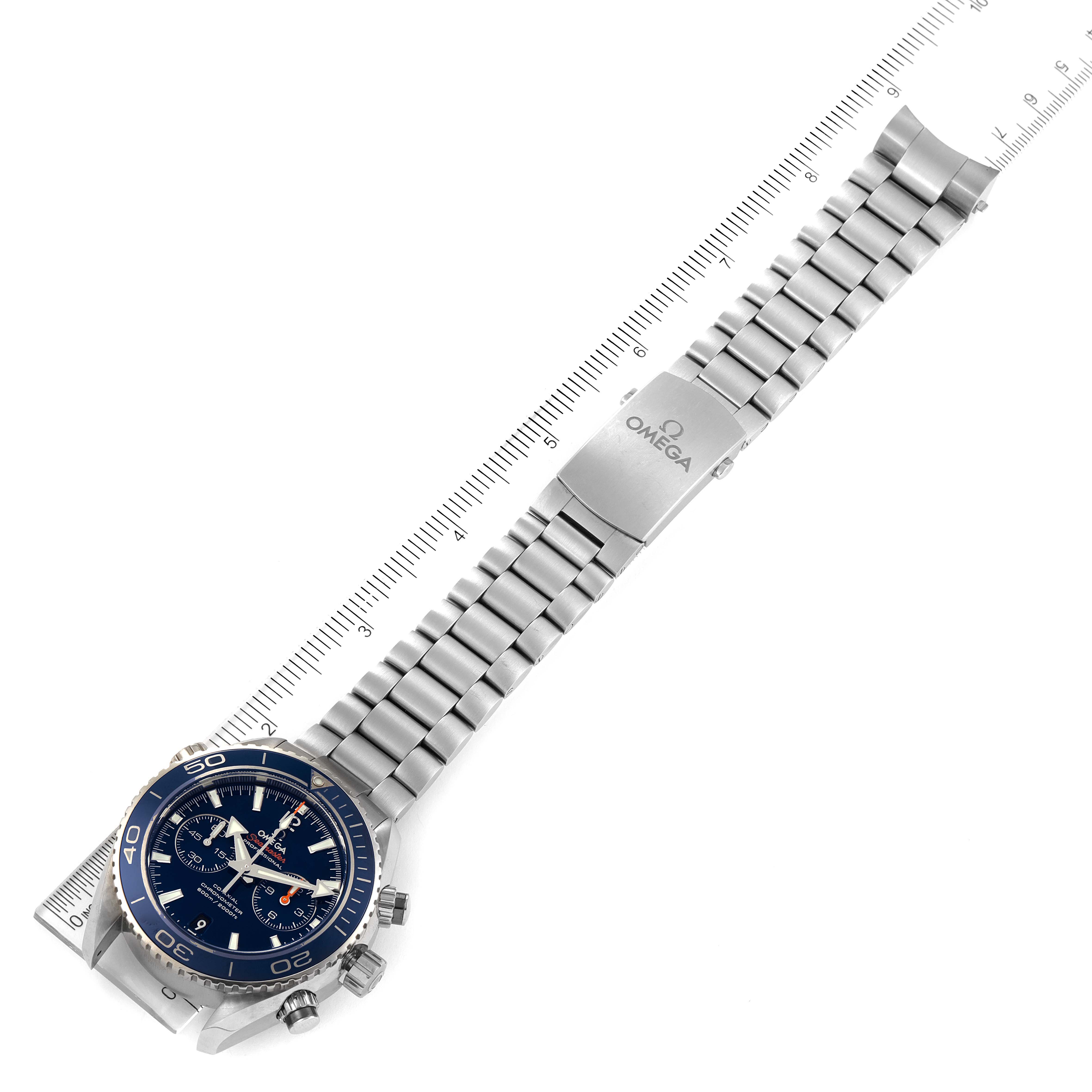 The image shows an Omega Planet Ocean 232.90.46.51.03.001 Men's Titanium Blue Dial 232.90.46.51.03.001 Men's Titanium Blue Dial watch with a stainless steel bracelet, displayed with a ruler measuring its length.