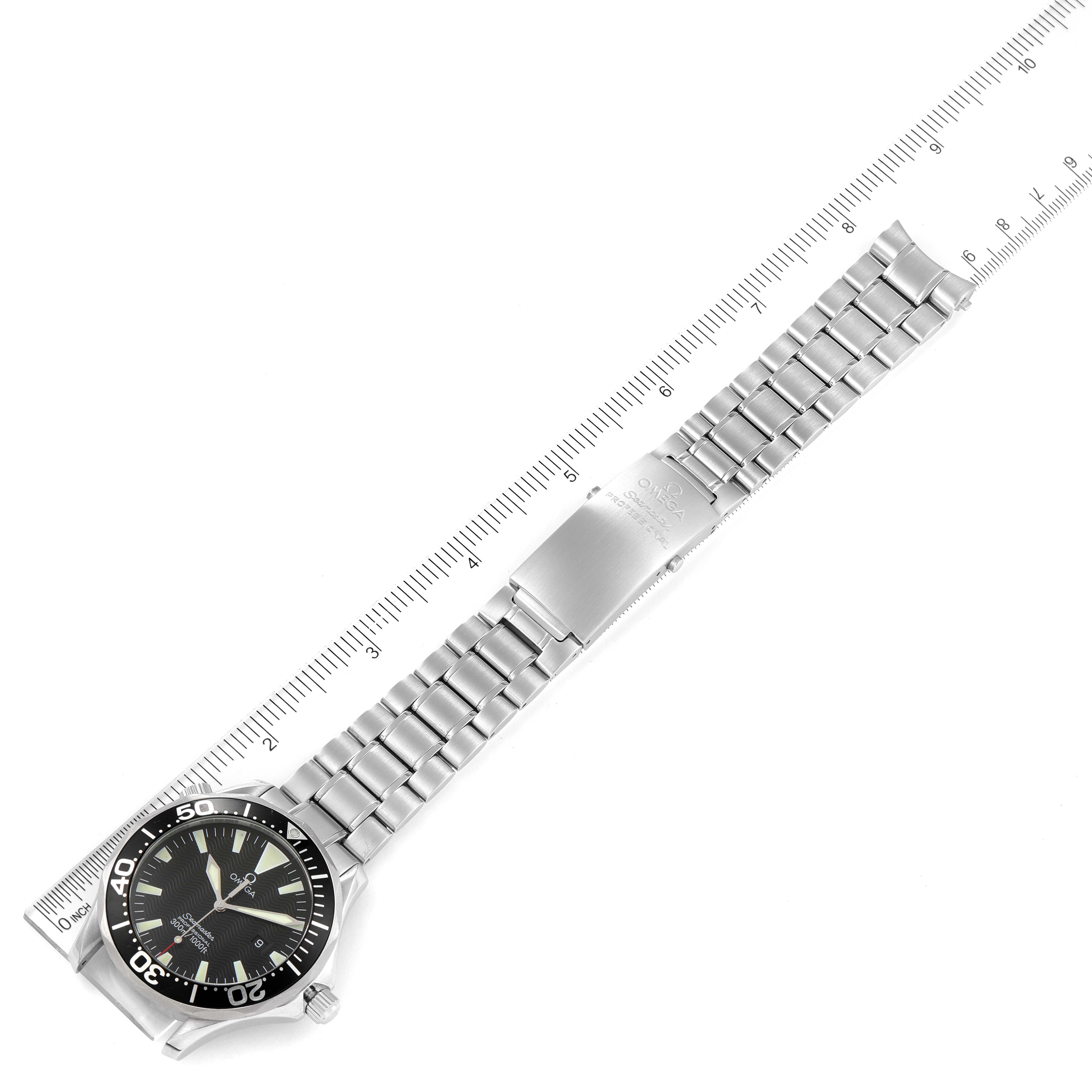 The image shows an overhead view of an Omega Seamaster 2264.50.00 Men's Stainless Steel Black Dial 2264.50.00 Men's Stainless Steel Black Dial watch, featuring the entire watch face, bracelet, and clasp, aligned with a ruler.