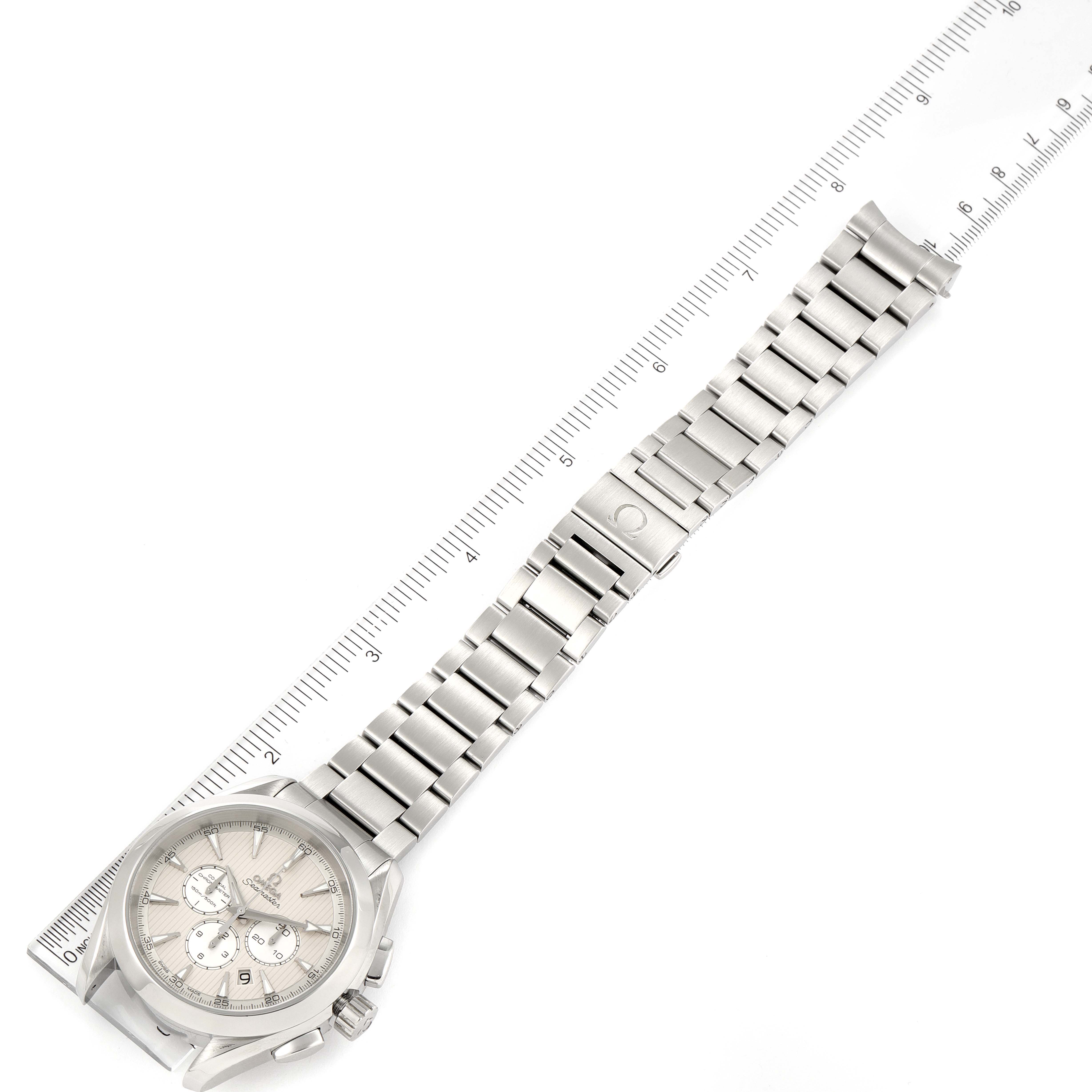 The image shows an Omega Aqua Terra 231.10.44.50.09.001 Men
s Stainless Steel White Dial 231.10.44.50.09.001 Men
s Stainless Steel White Dial watch from a top-down angle, along with a ruler measuring its length.