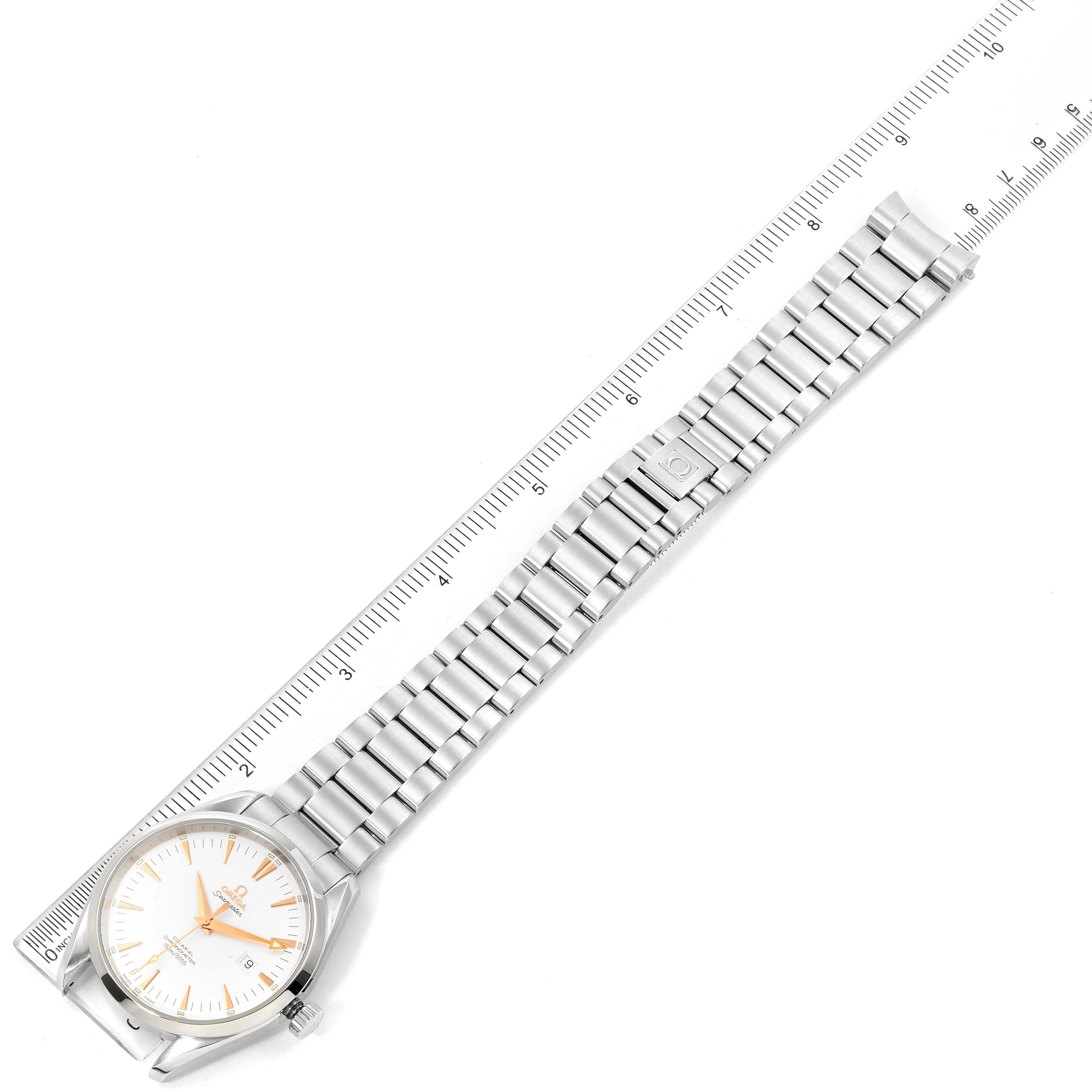 The image shows an overhead view of an Omega Aqua Terra 2502.34.00 Men's Stainless Steel Silver Dial 2502.34.00 Men's Stainless Steel Silver Dial watch with a ruler placed next to its metal bracelet.